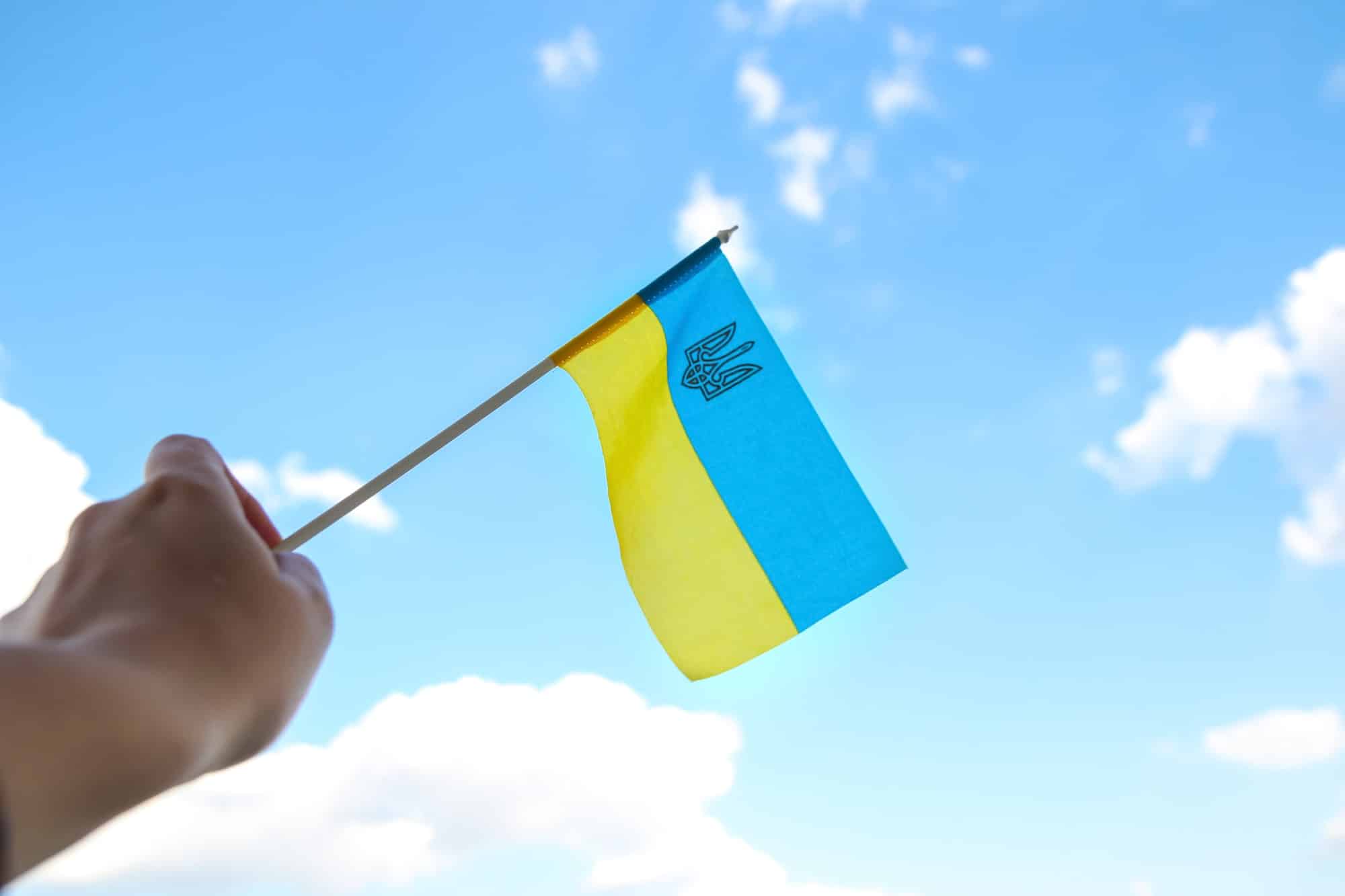 Ukraine flag. Large national symbol fluttering in blue sky. Support and help Ukraine, Independence C