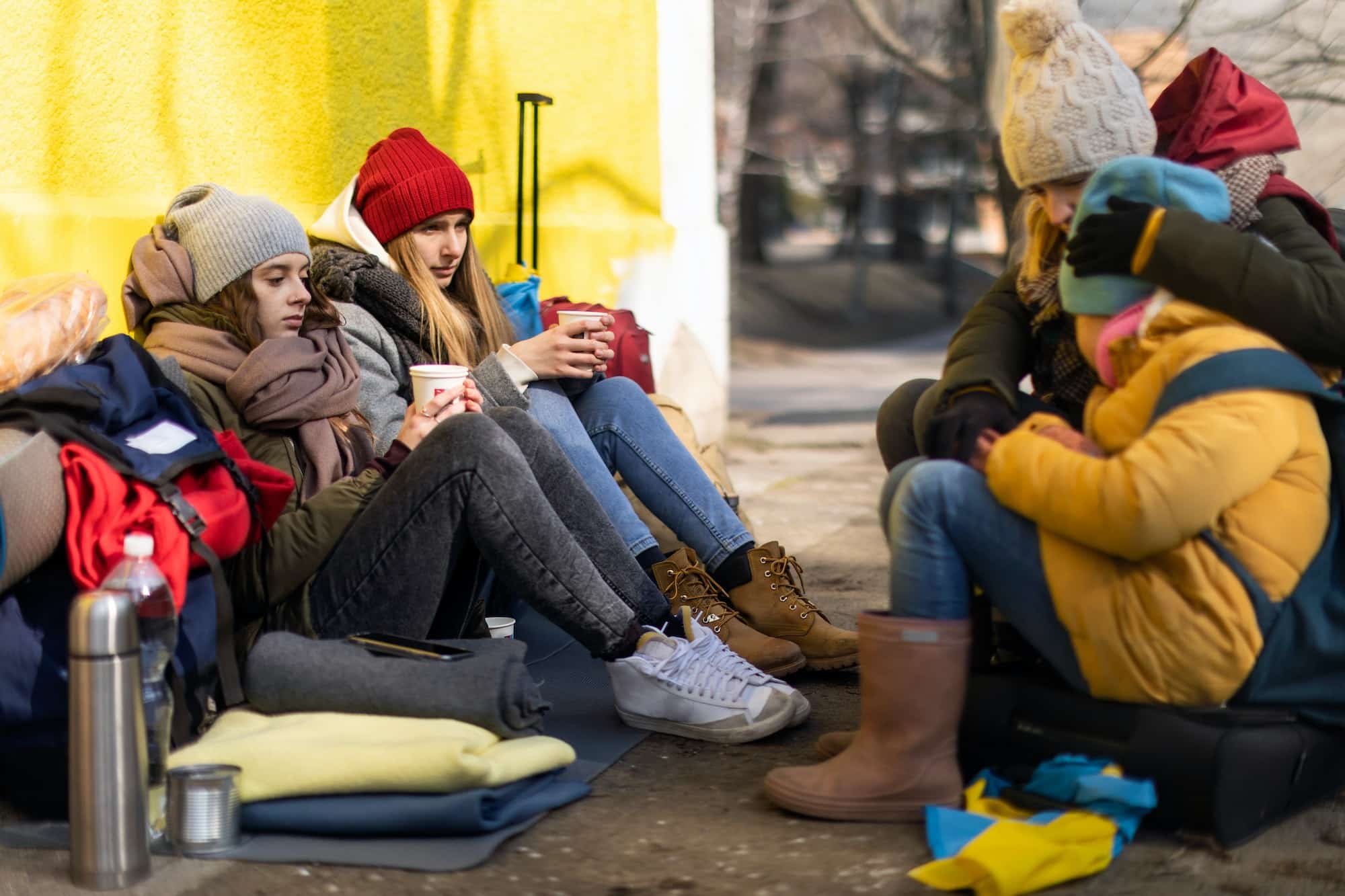 Ukrainian immigrants crossing border and sitting and waiting for registration