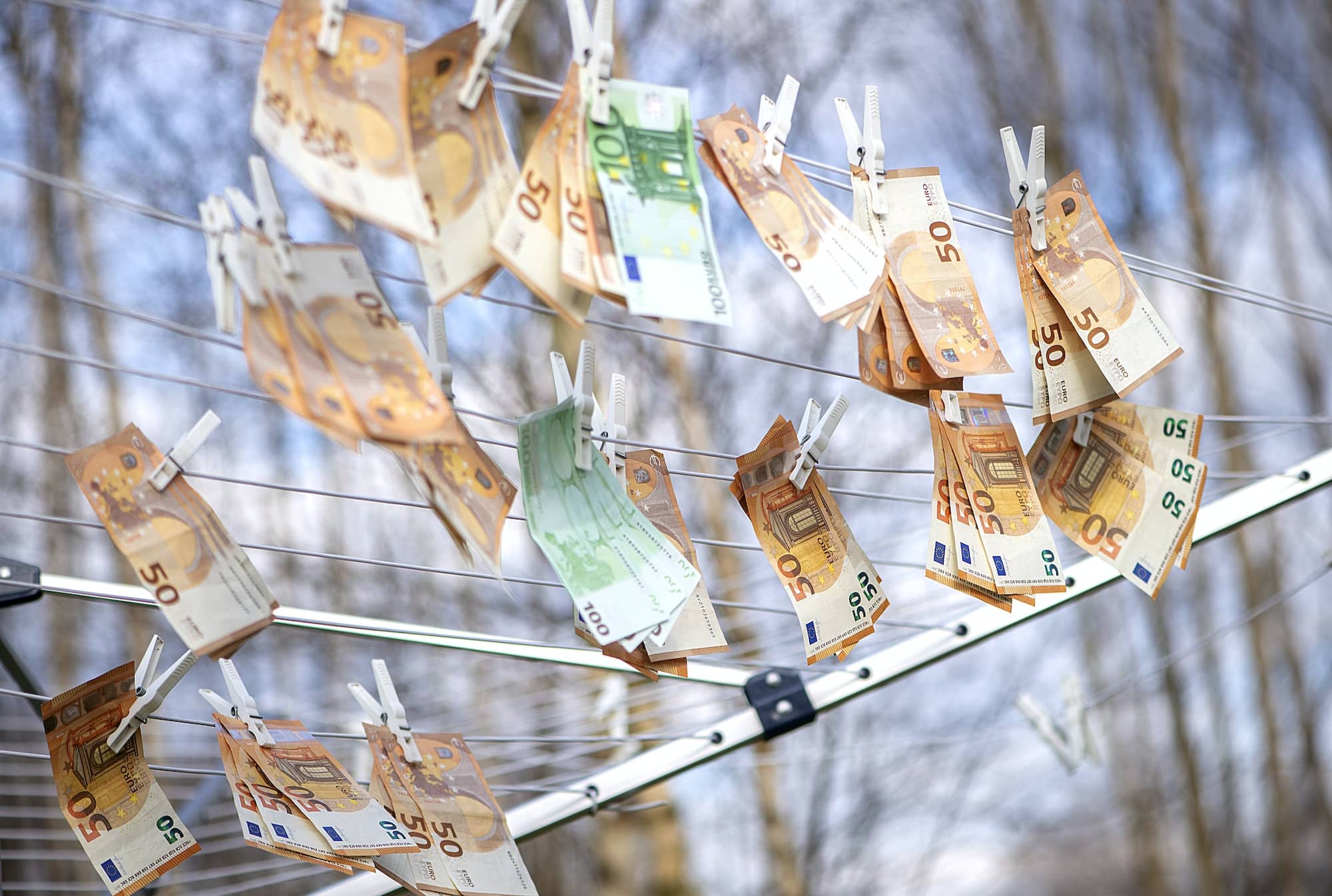 100 and 50 euro banknotes drying. Washed Euro paper bills. Drying euro on a string.