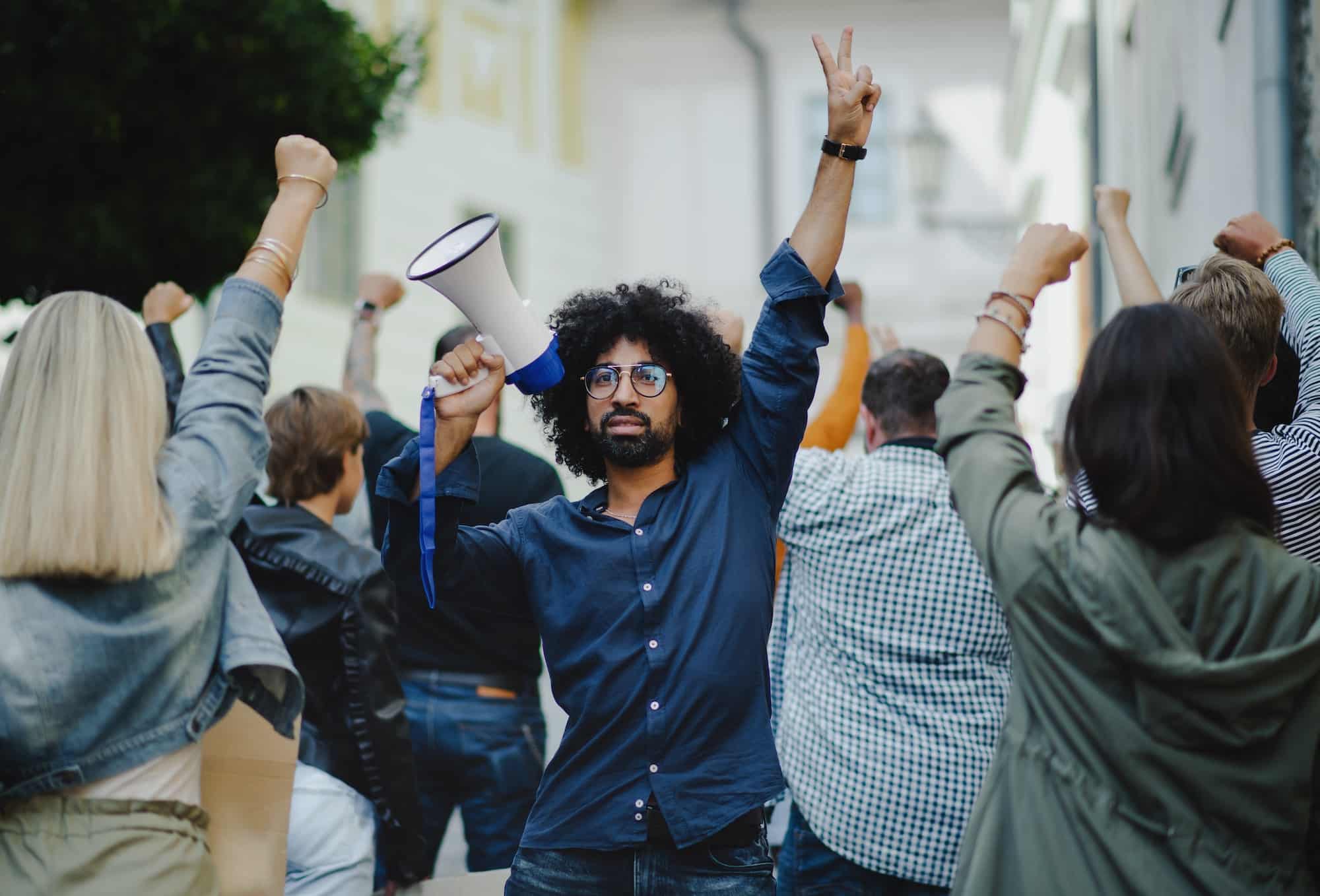 Group of people activists protesting on streets, strike and demonstration concept.