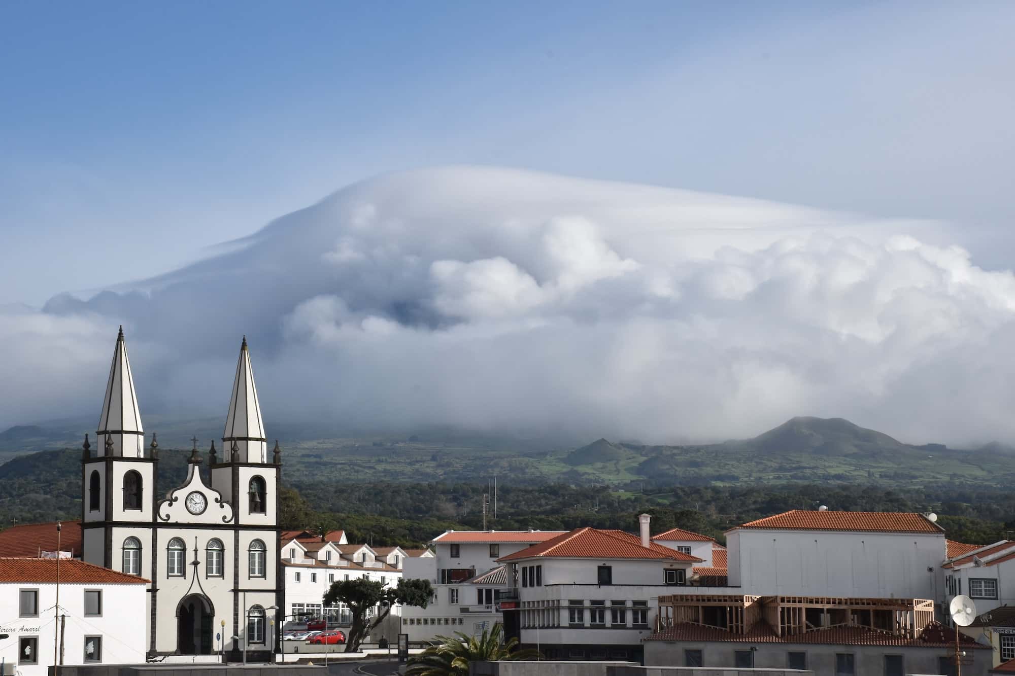 Madalena town on Pico island with mountain Pico covered with clouds, Azores, Portugal