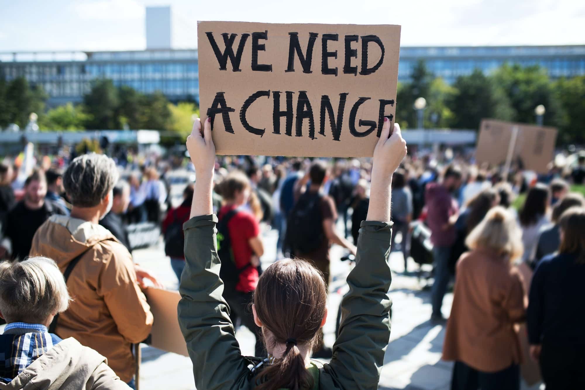 Rear view of people with placards and posters on global strike for climate change