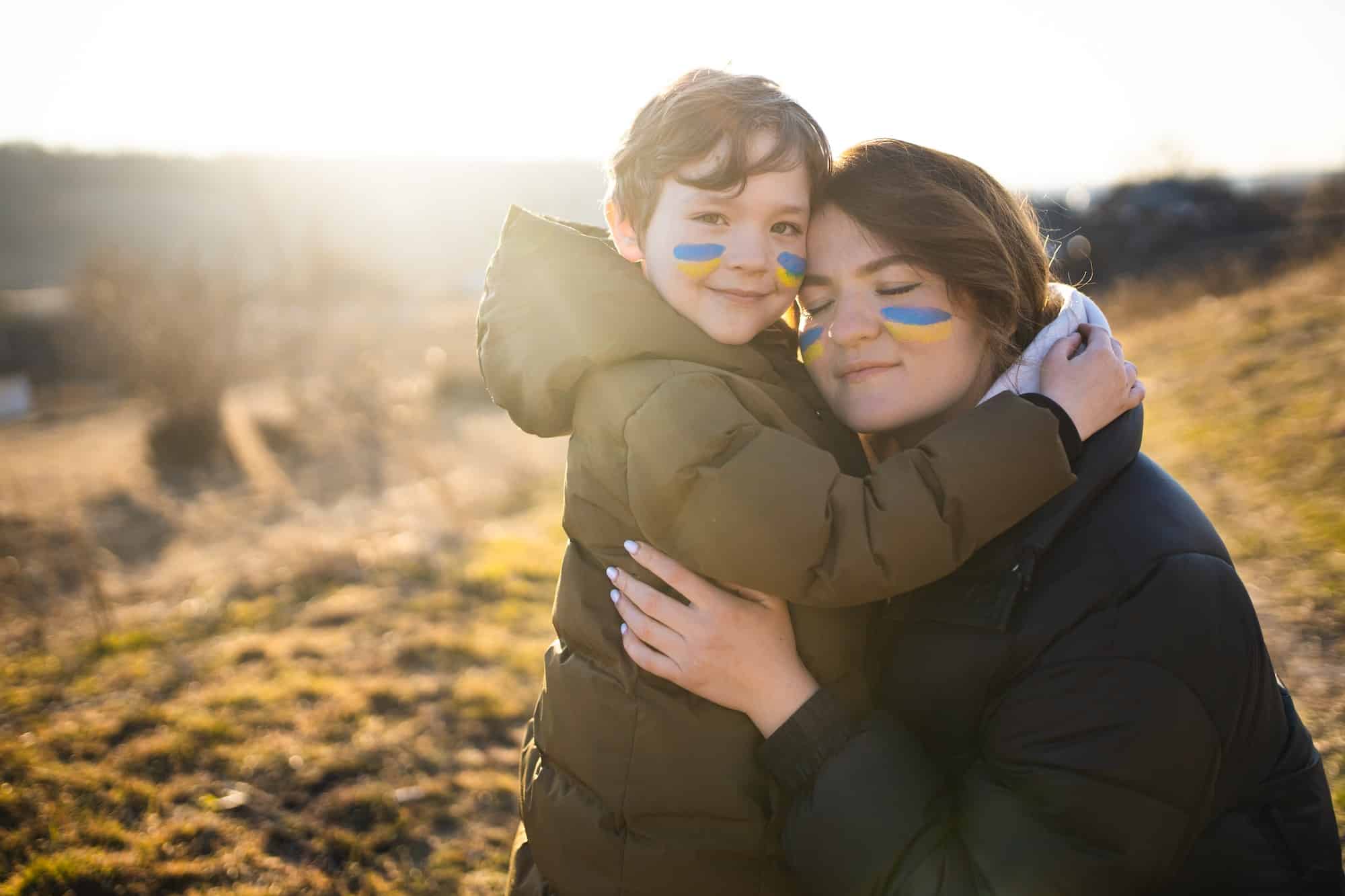 Ukrainian mother with her son. Patriots of Ukraine. Refugees from Ukraine. War against Ukraine.