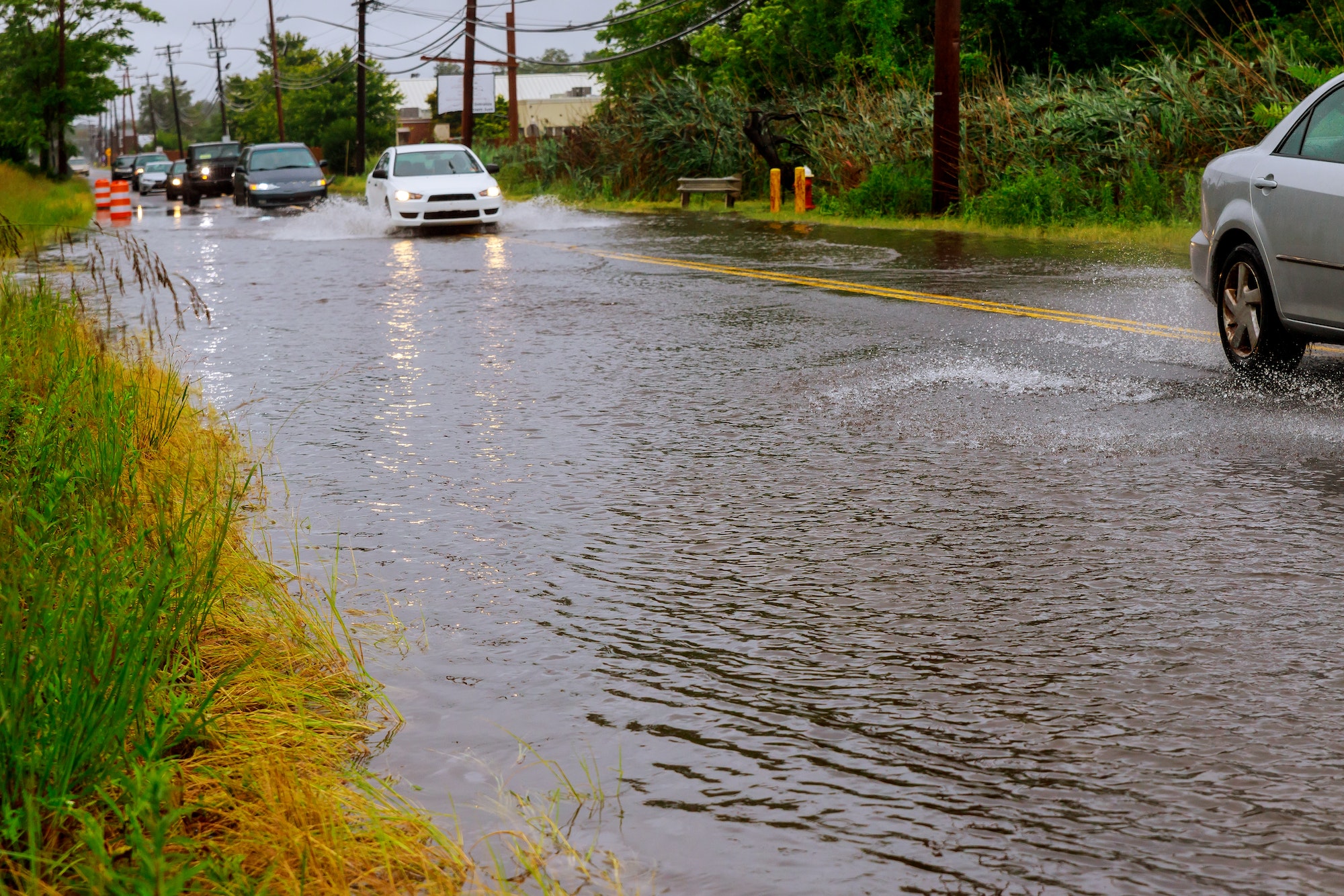 Cars on the street flooded with rain flood road cars on the road