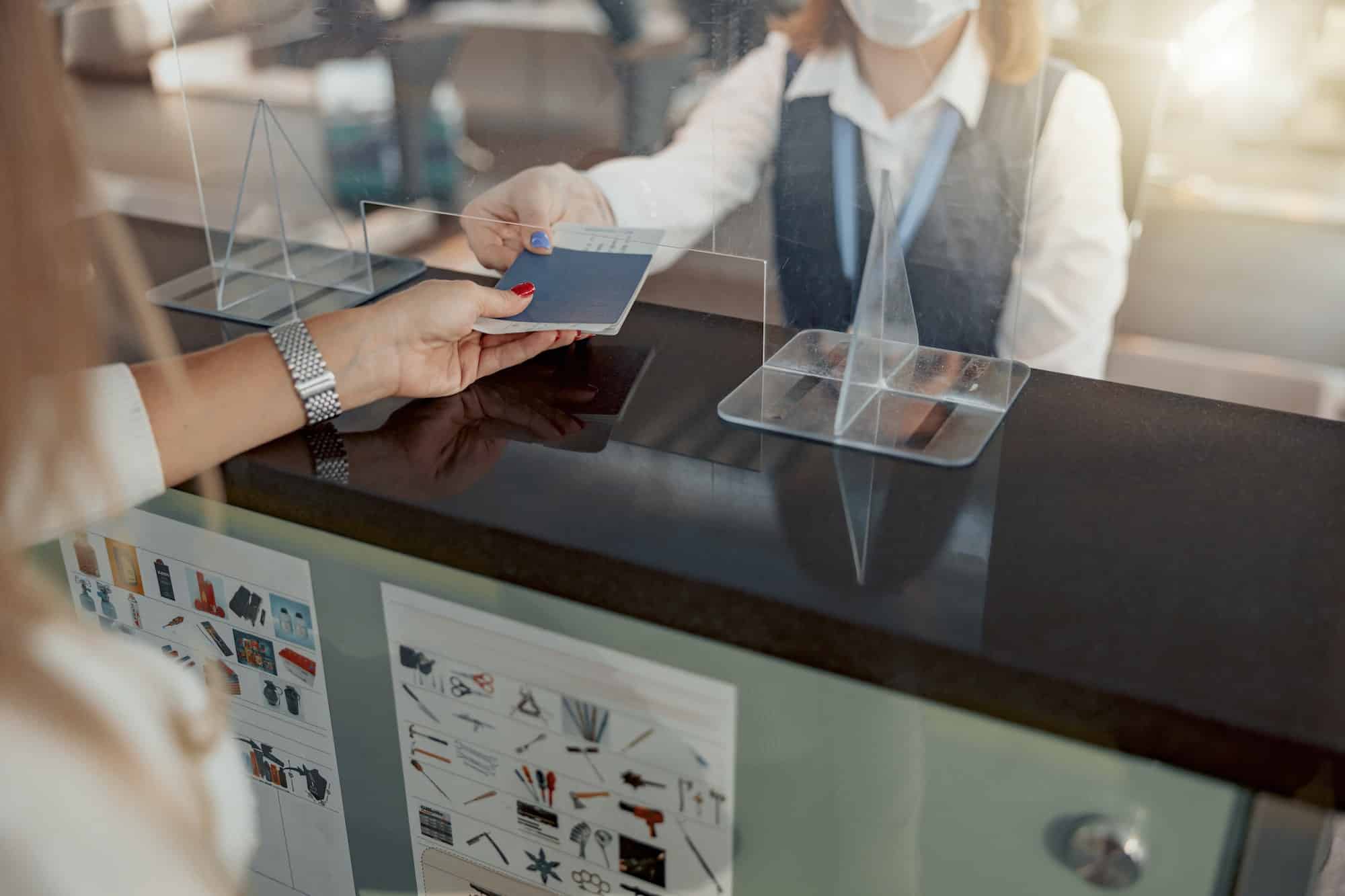 Female employee of airport checking passports and biometric data