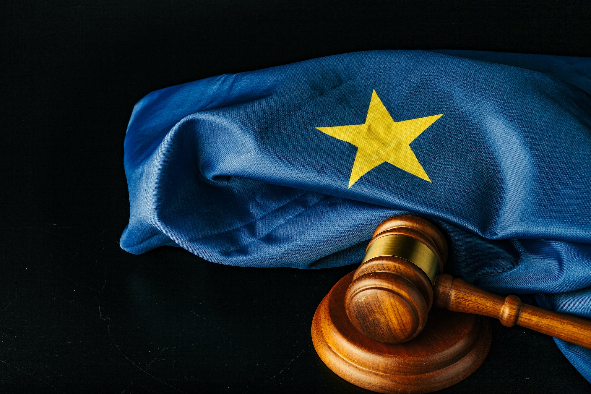 Gavel and european union flag on black background