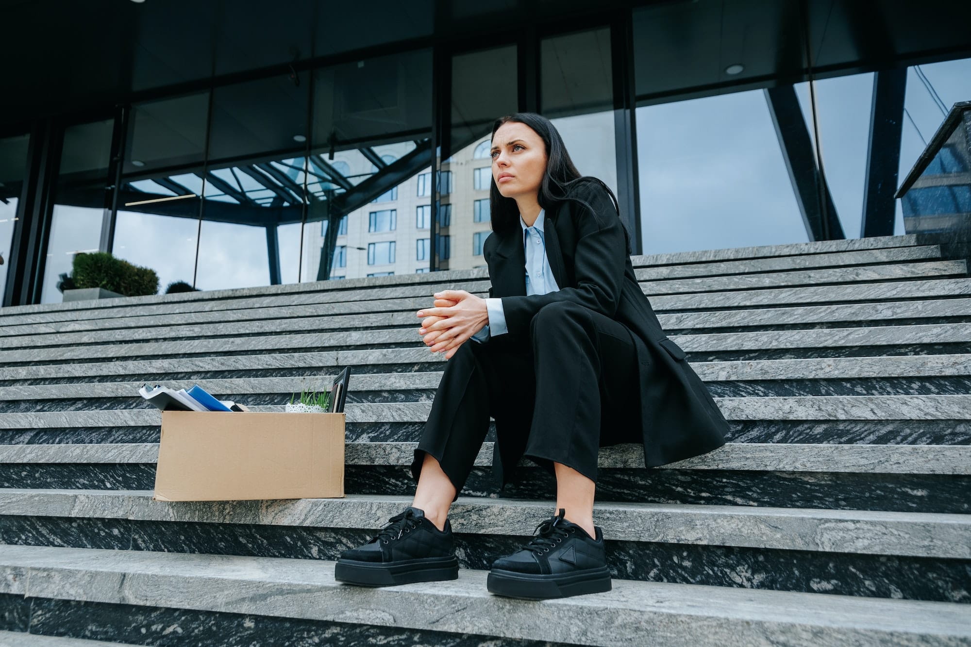 Lost Job, Lost Hope A Woman Sitting on Steps with a Jobless Sign