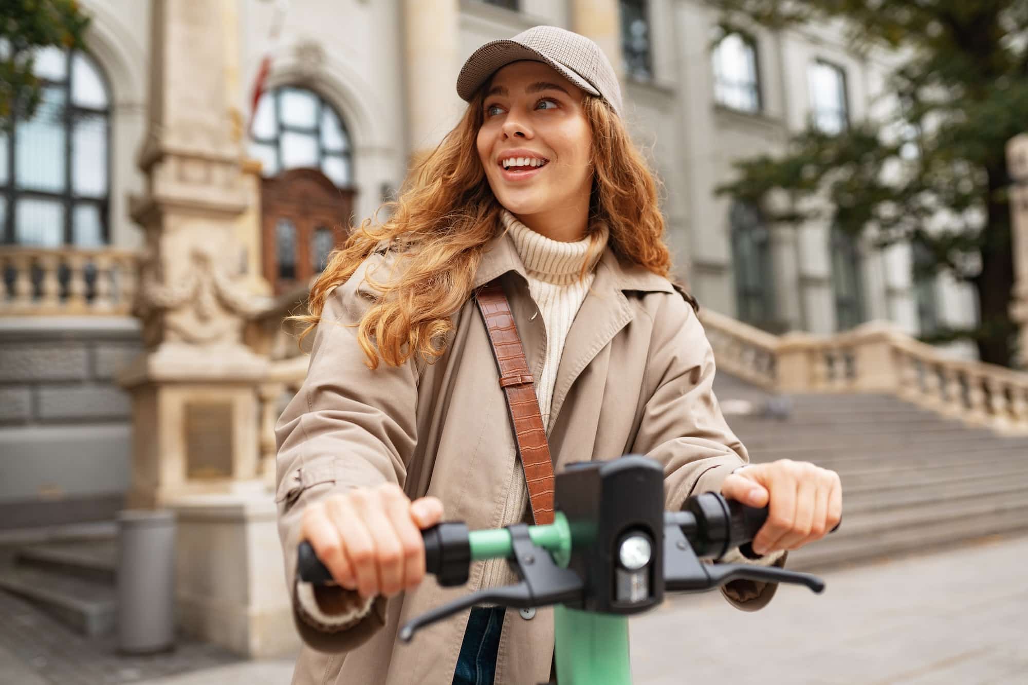 Young woman standing on electric scooter in the city