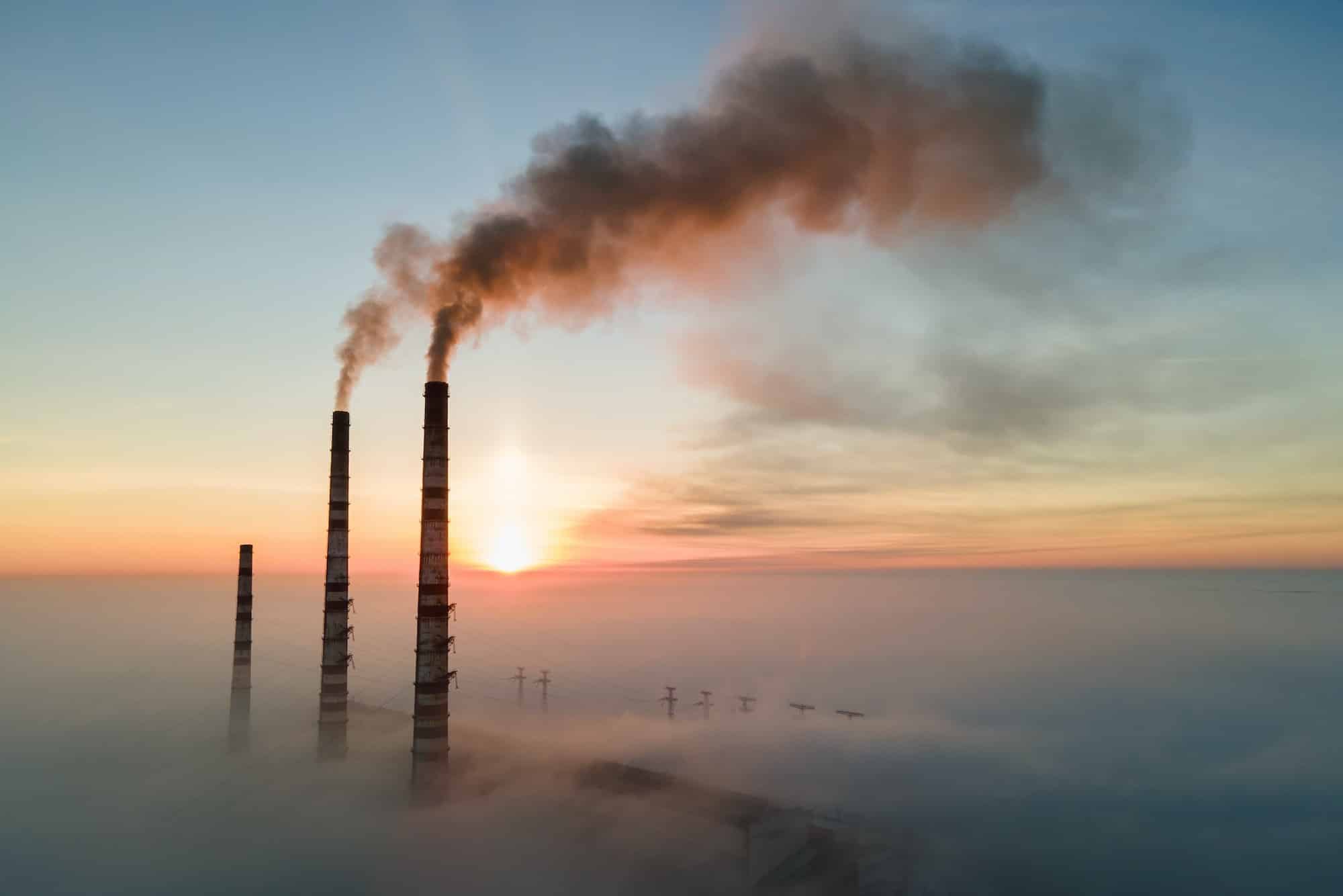 Aerial view of coal power plant high pipes with black smoke