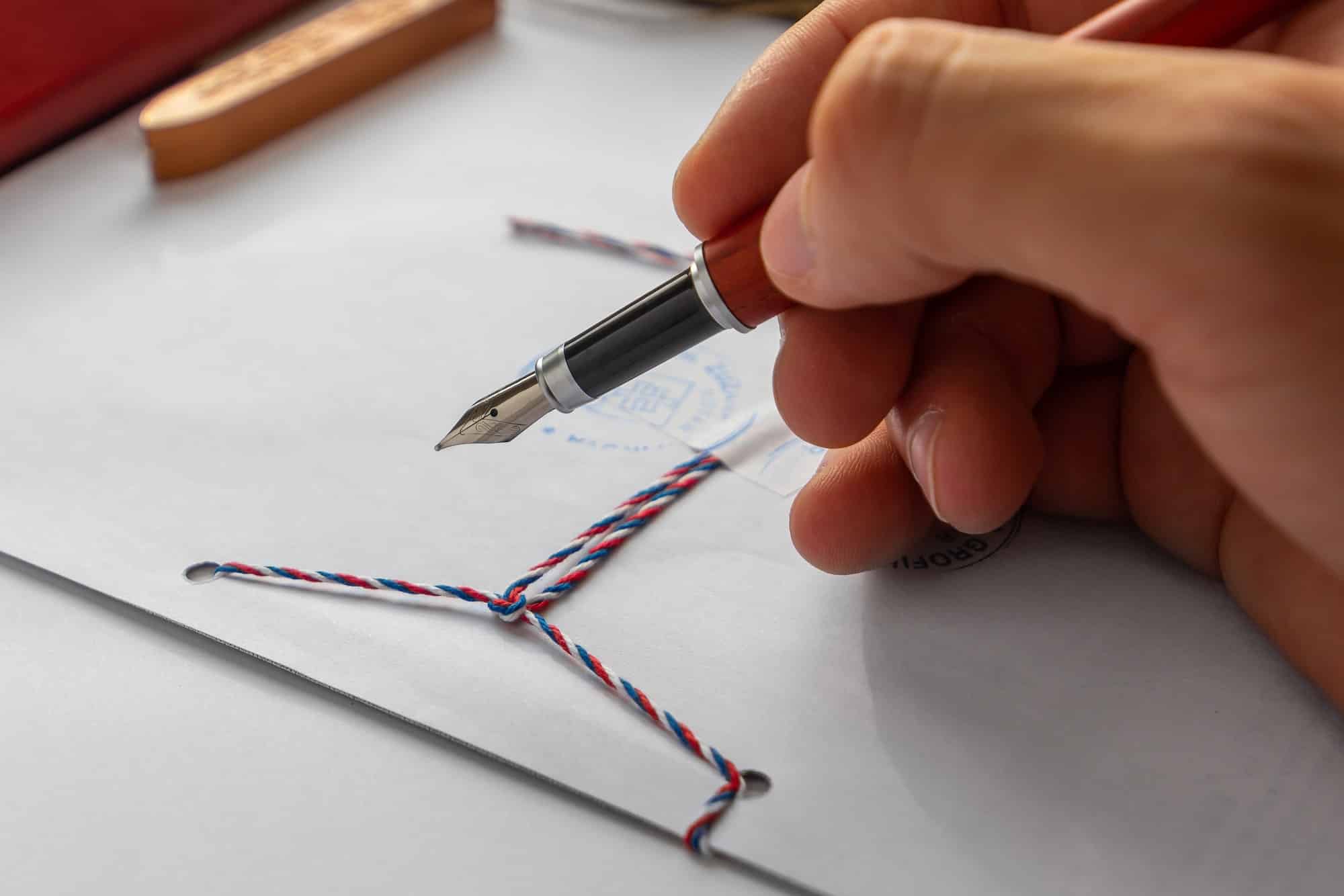 Notary public wax stamper. White envelope with brown wax seal, golden stamp. Responsive design