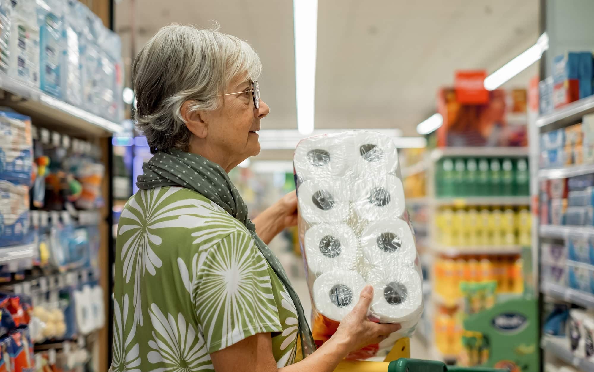 Senior woman doing shopping in supermarket - consumerism concept, rising prices, inflation