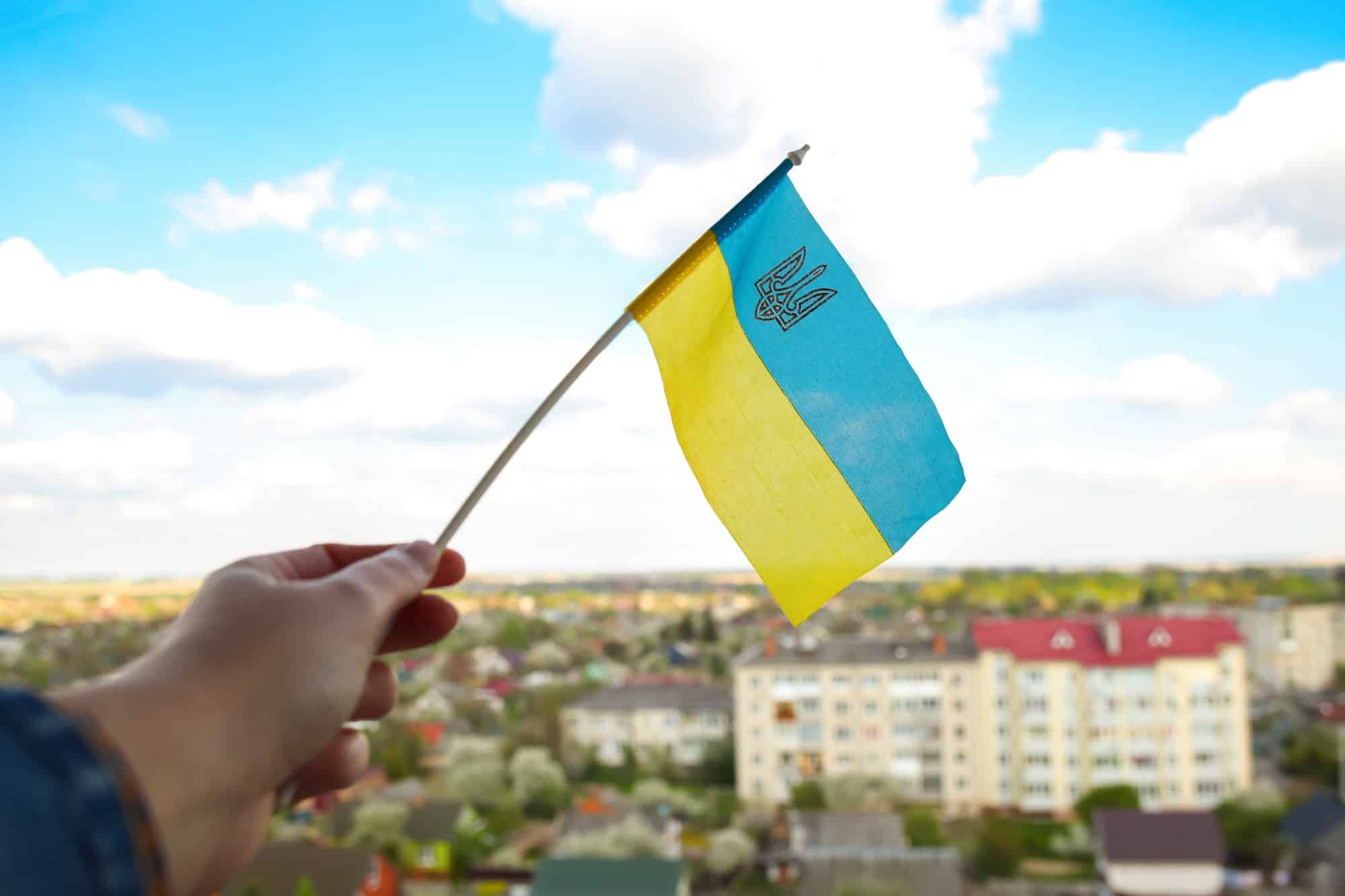 Ukraine flag. Large national symbol fluttering in blue sky. Support and help Ukraine, Independence C