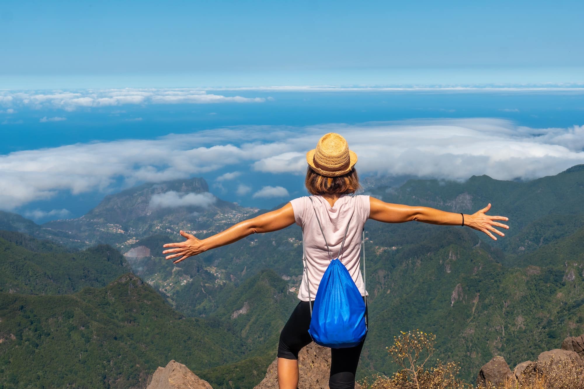 A young woman at the Miradouro do Juncal on Pico do Arieiro, Madeira. Portugal