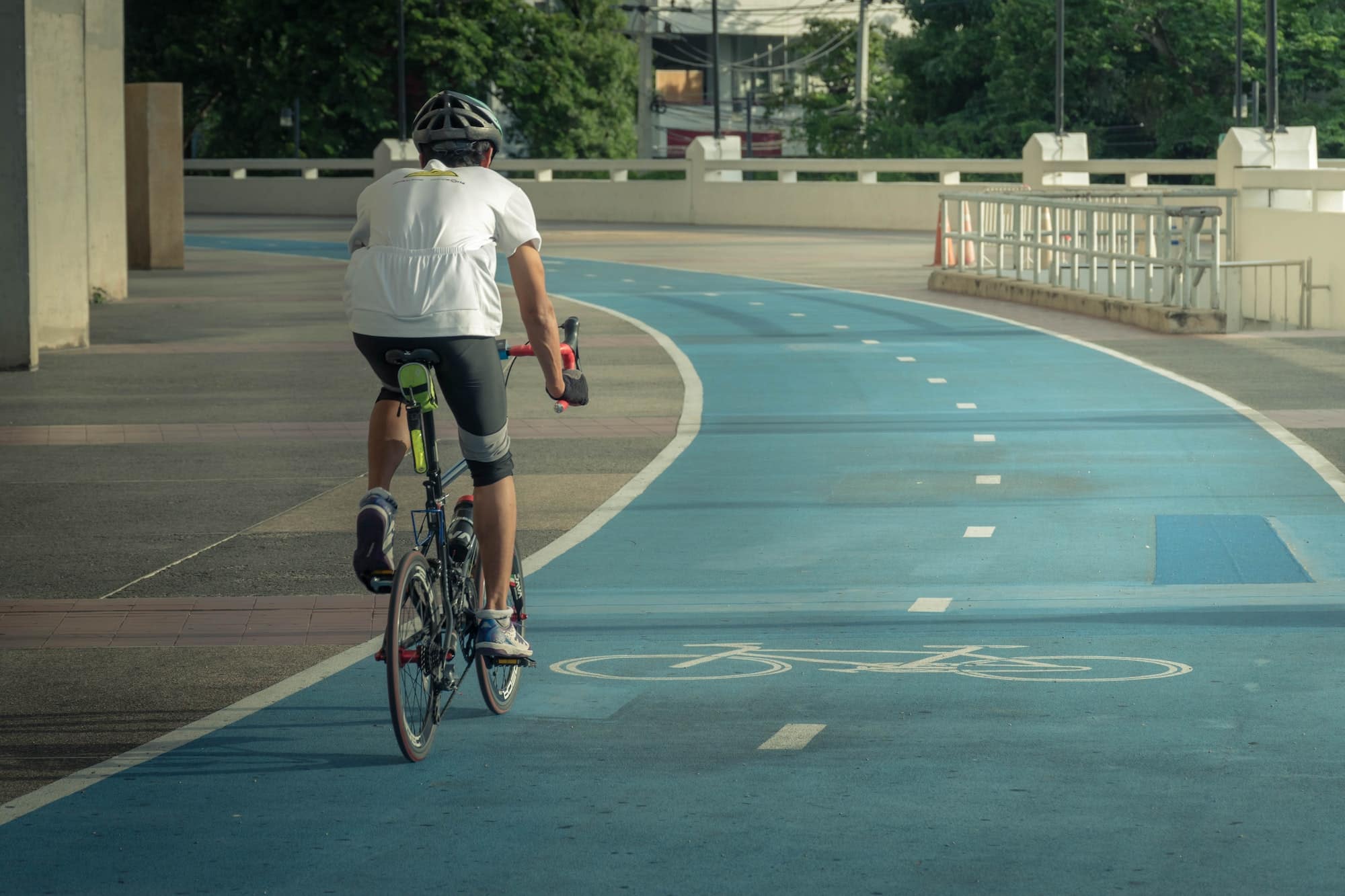 Asian man biking bicycle on bicycle path for cycling bicycle