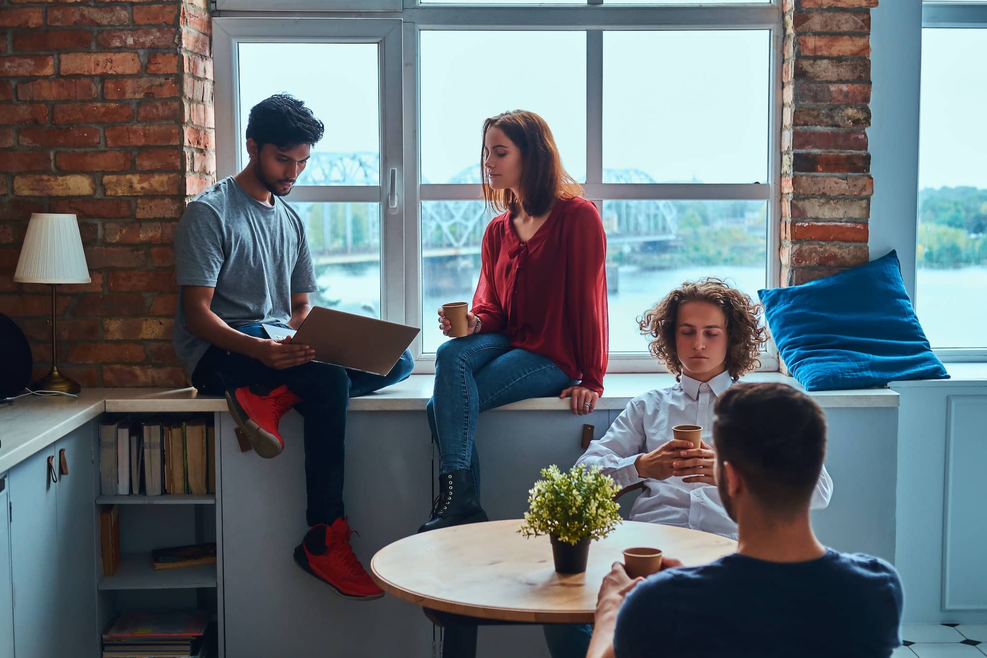 Group of interracial students resting in student dormitory.