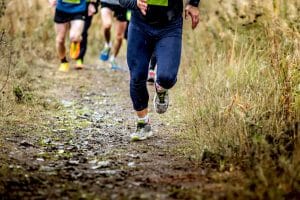 group runners running uphill