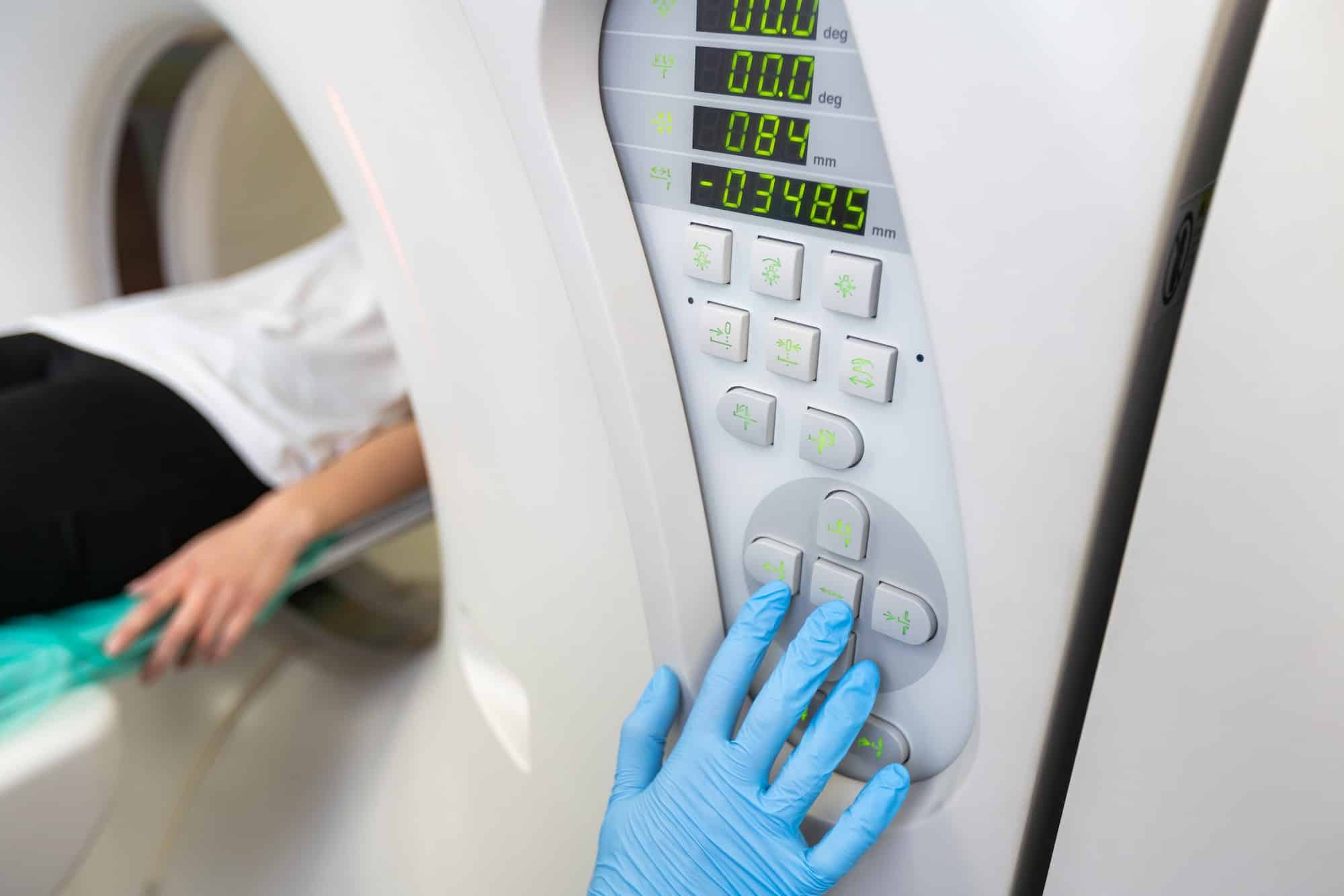 Radiologist with a female patient in the room of computed tomography.