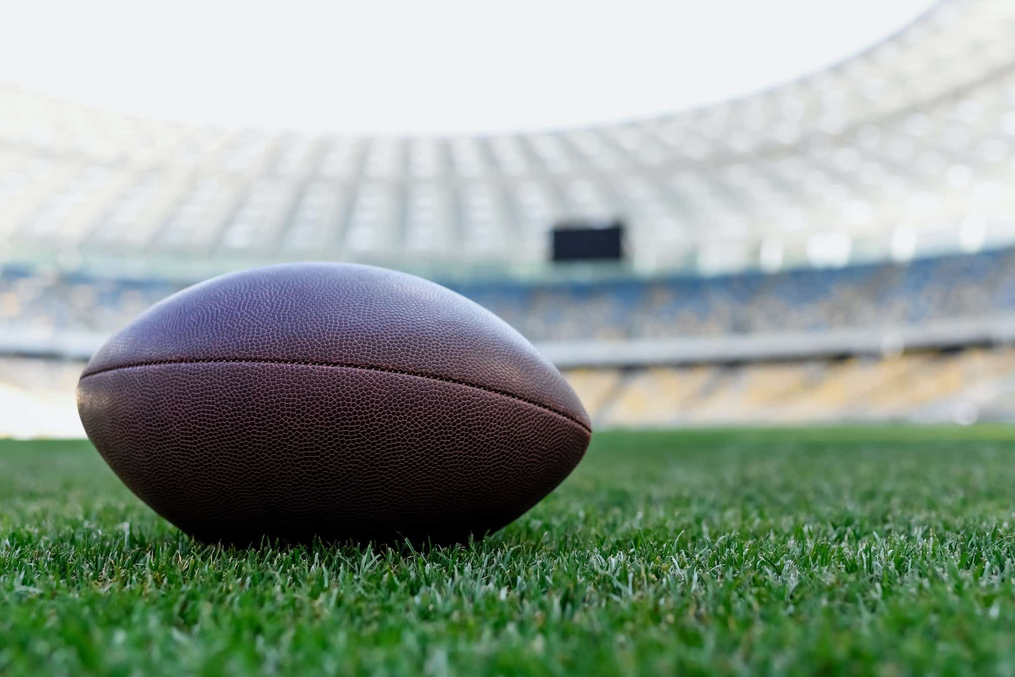 rugby ball on green grass at stadium