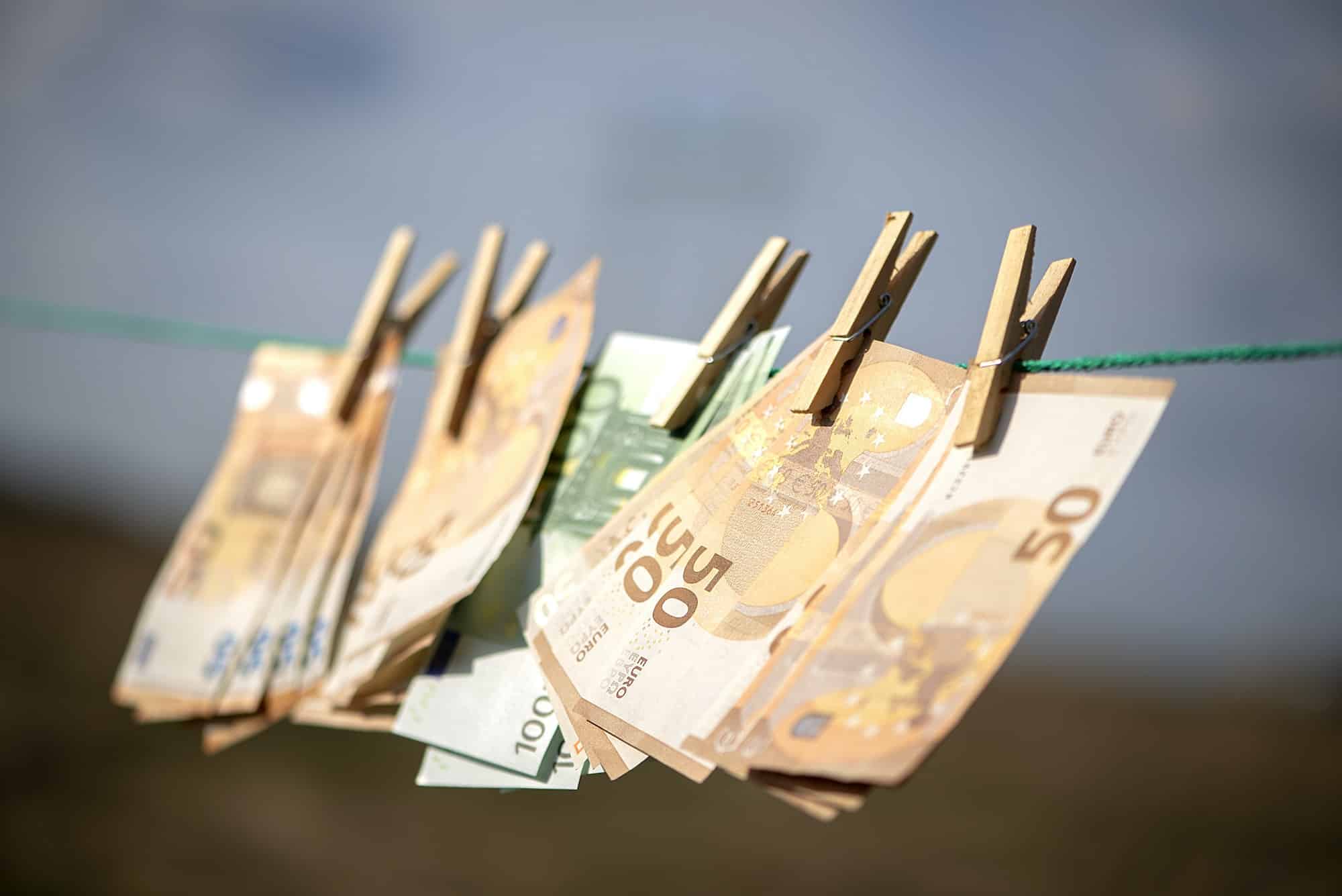 100 and 50 euro banknotes drying. Washed Euro paper bills. Drying euro on a string.