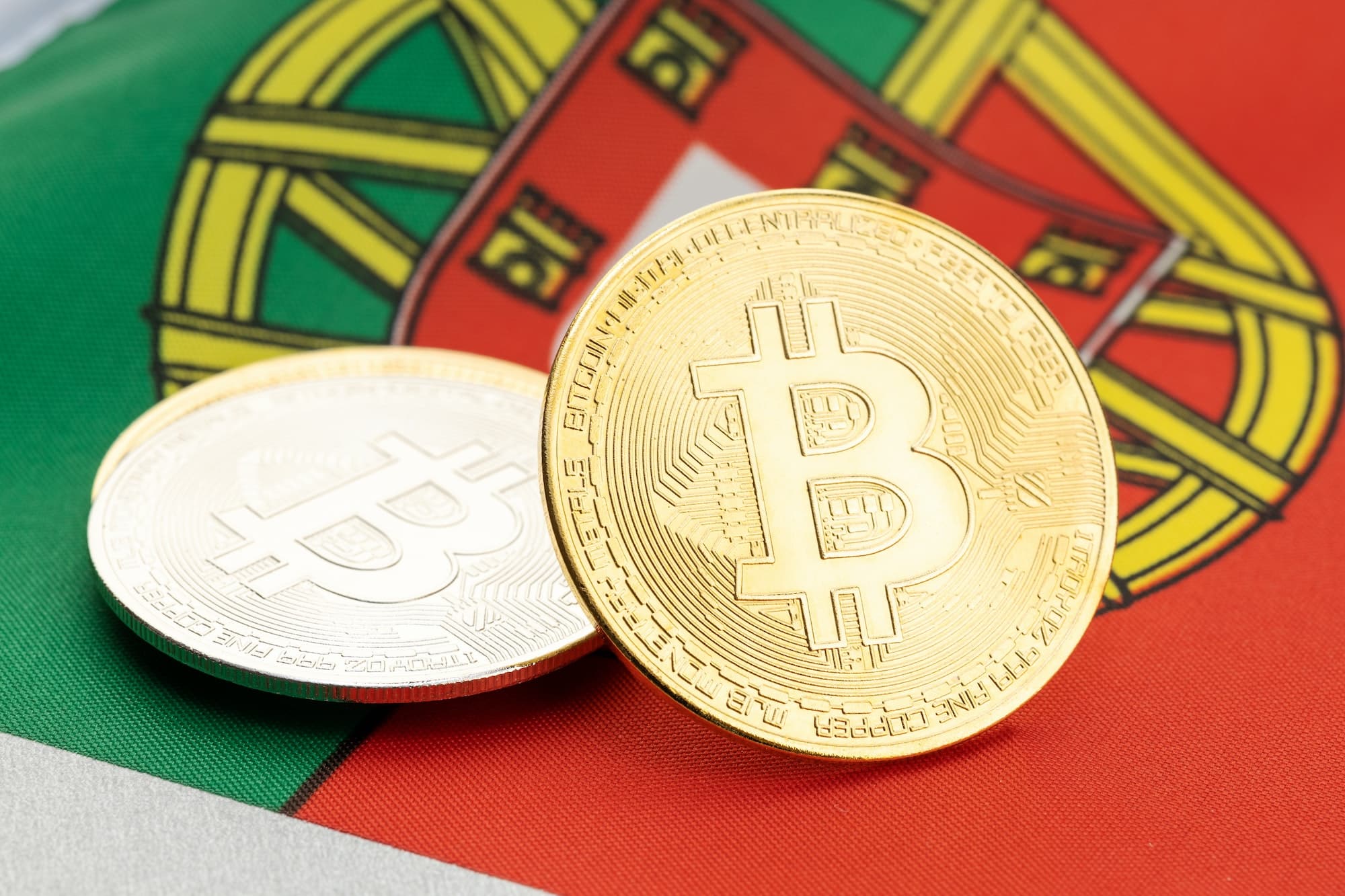 Bitcoin cryptocurrency coins on national flag of Portugal