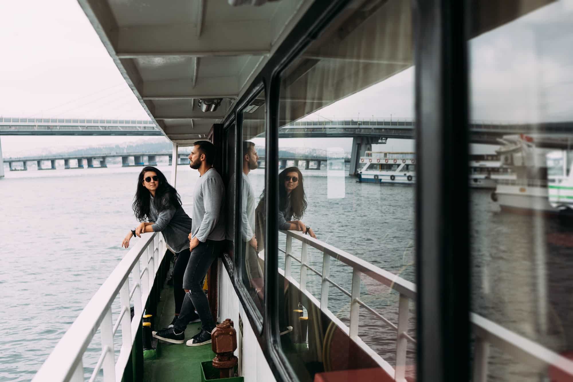 Guy and girl on board a cruise boat. Man and woman traveling. Honeymoon trip