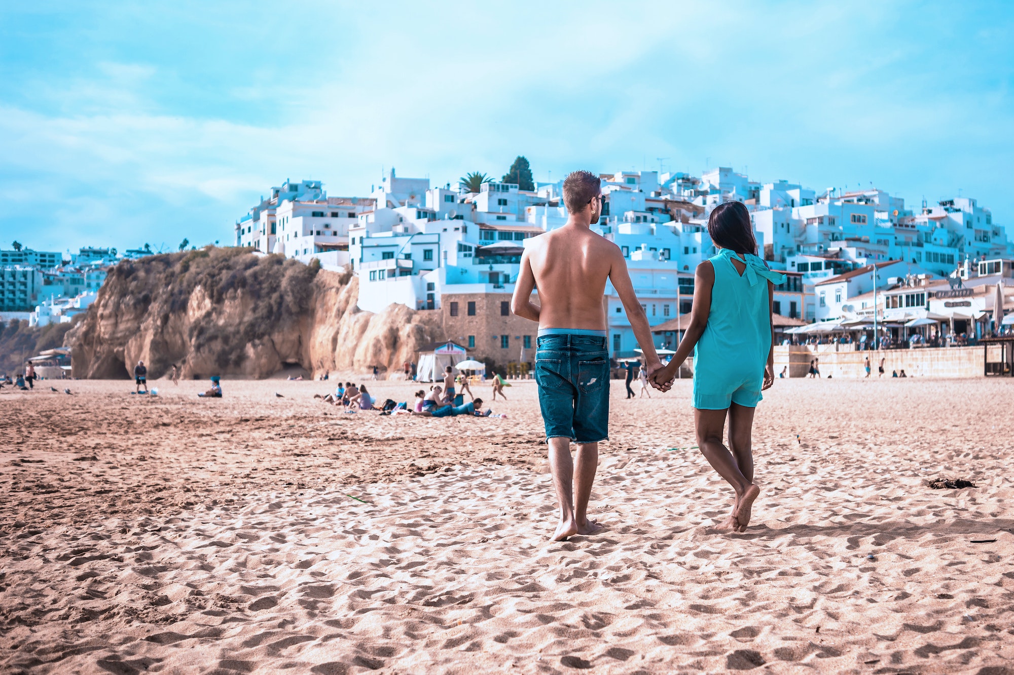 happy Young couple walking at the beach of Albufeira Algarve Portugal