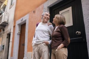 Positive Senior Tourists Spouses Standing On A Street In Lisbon