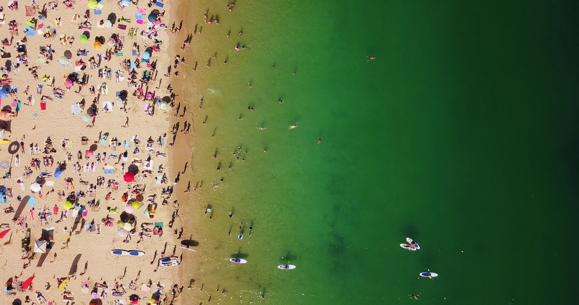 Aerial Summer View Of People Crowd Having Fun On Cascais Beach In Portugal