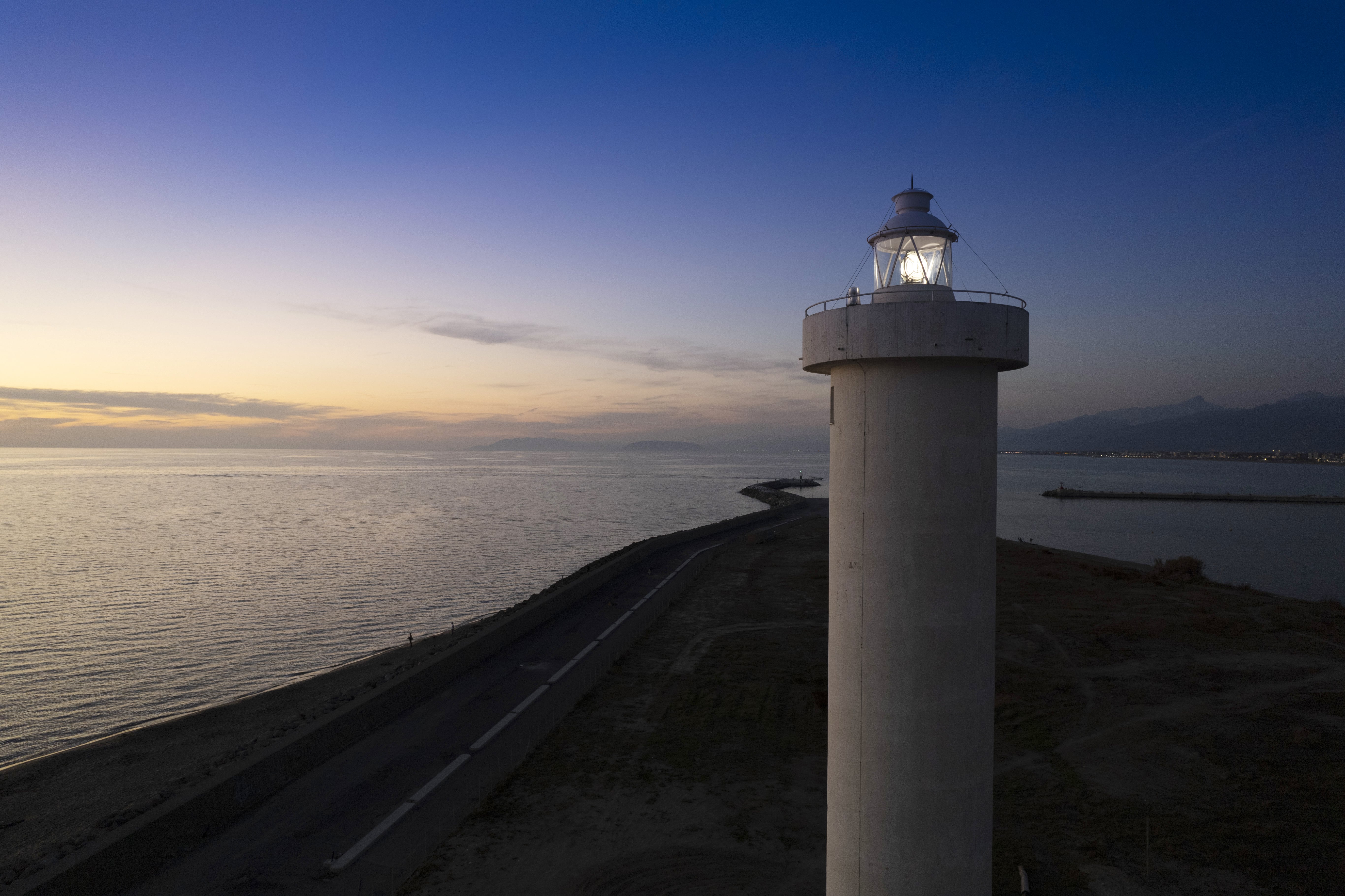 Aerial view of a maritime lighthouse taken at night