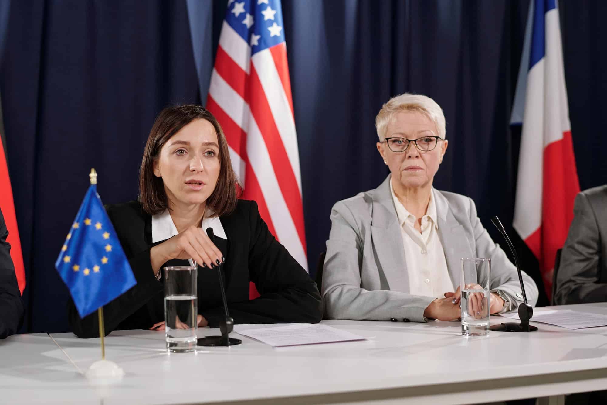 Young female representative of European Union speaking in microphone