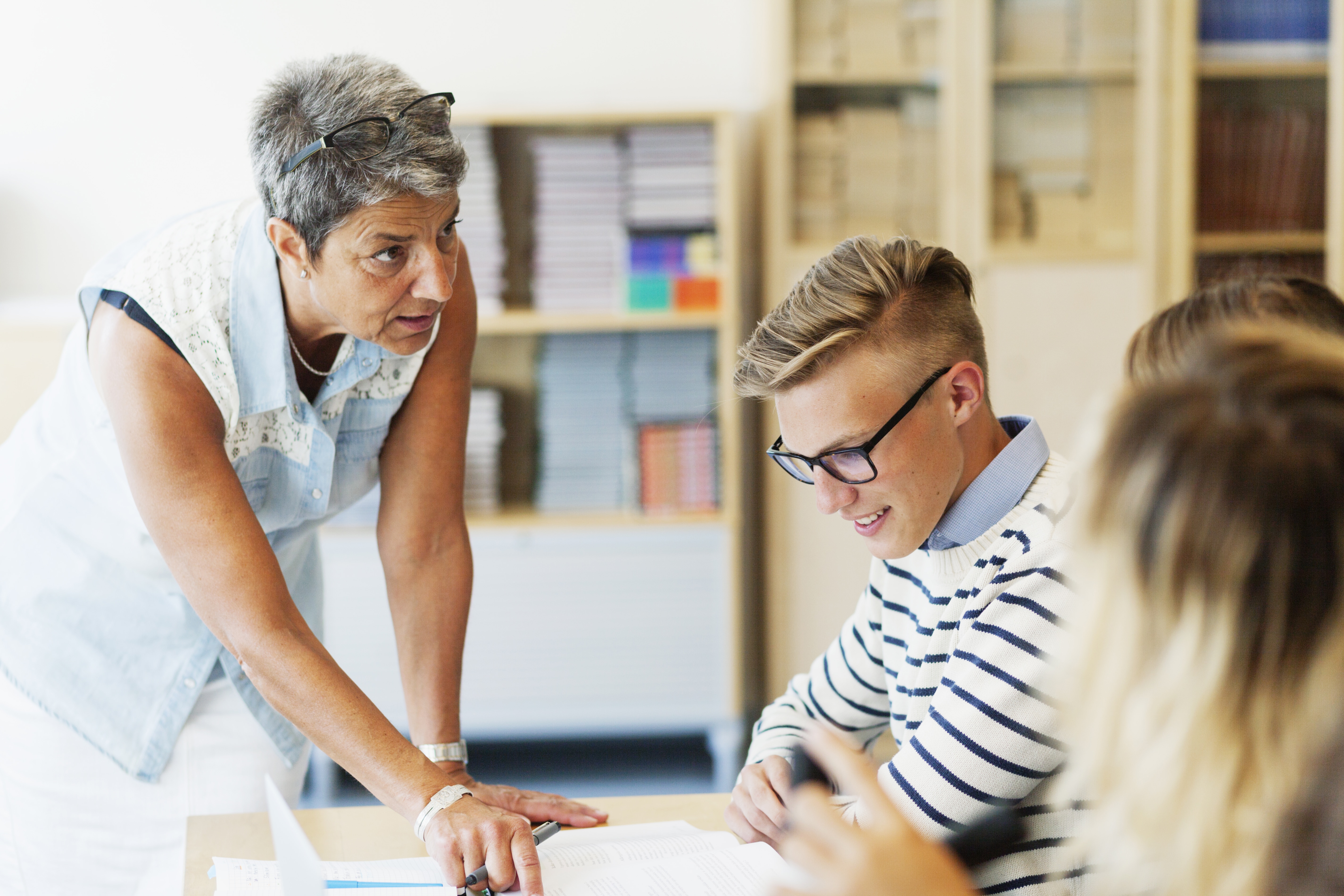 Mature teacher explaining students in classroom