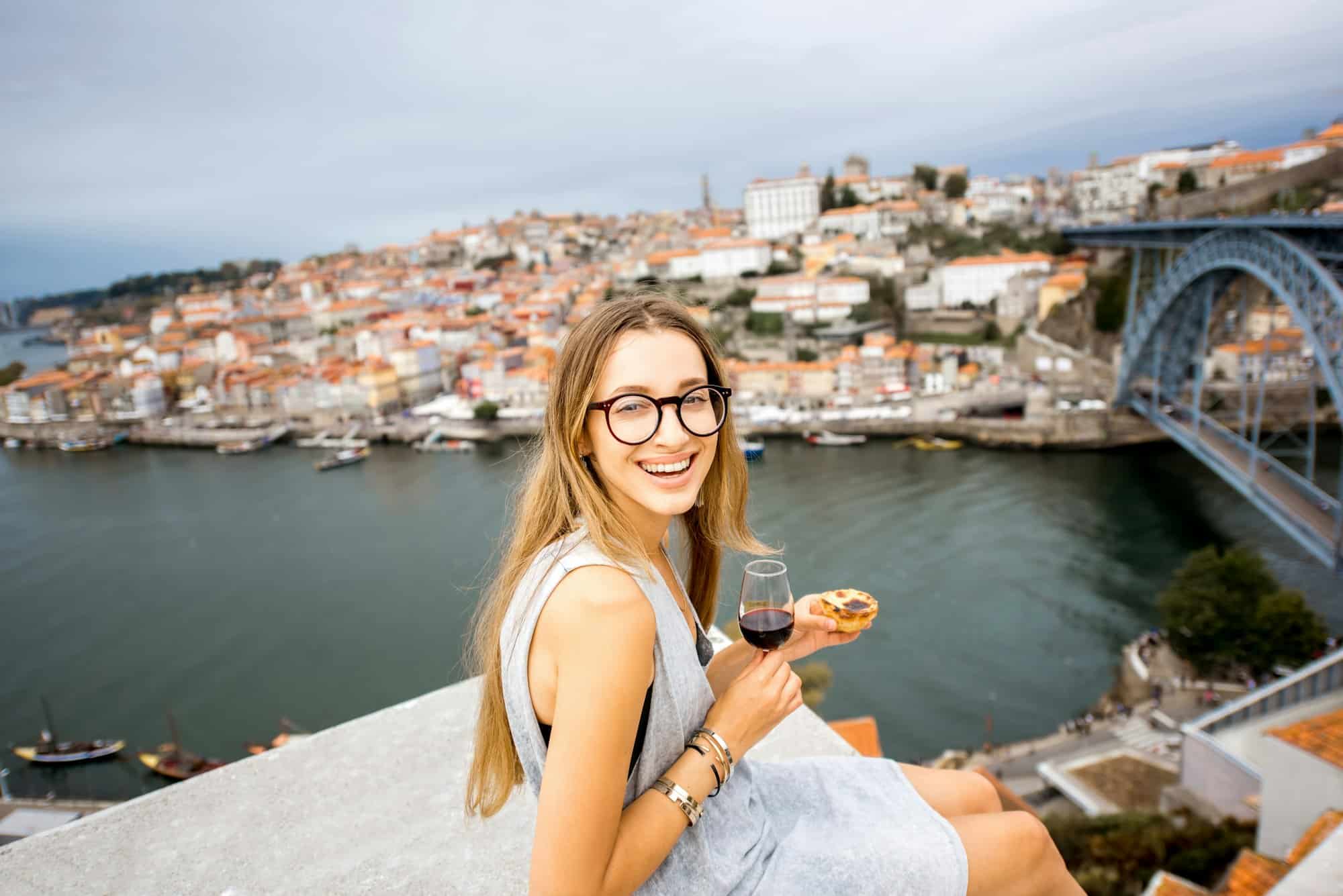 Woman with portuguese dessert in Porto