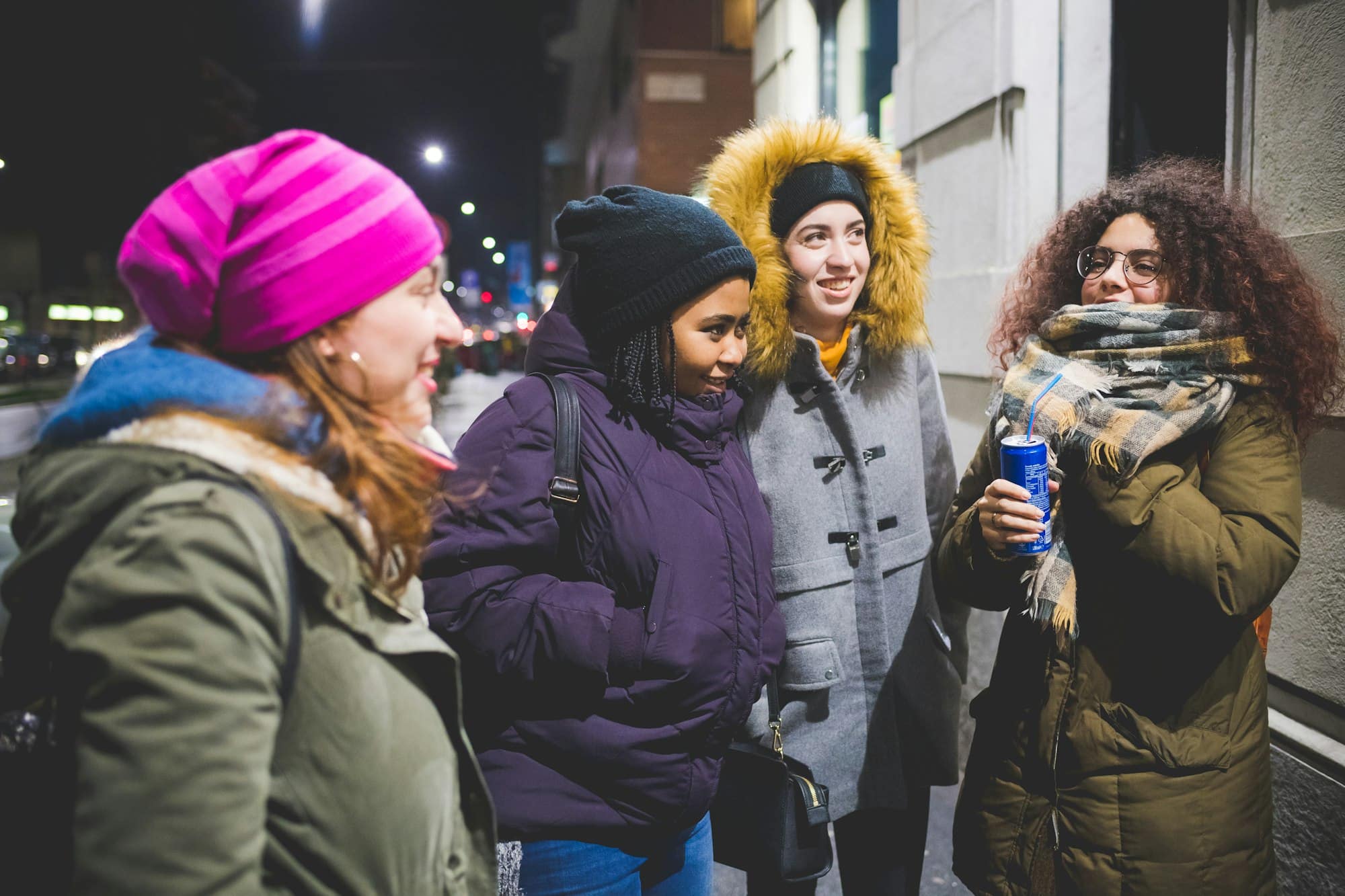 group of young women standing in the street and having conversation