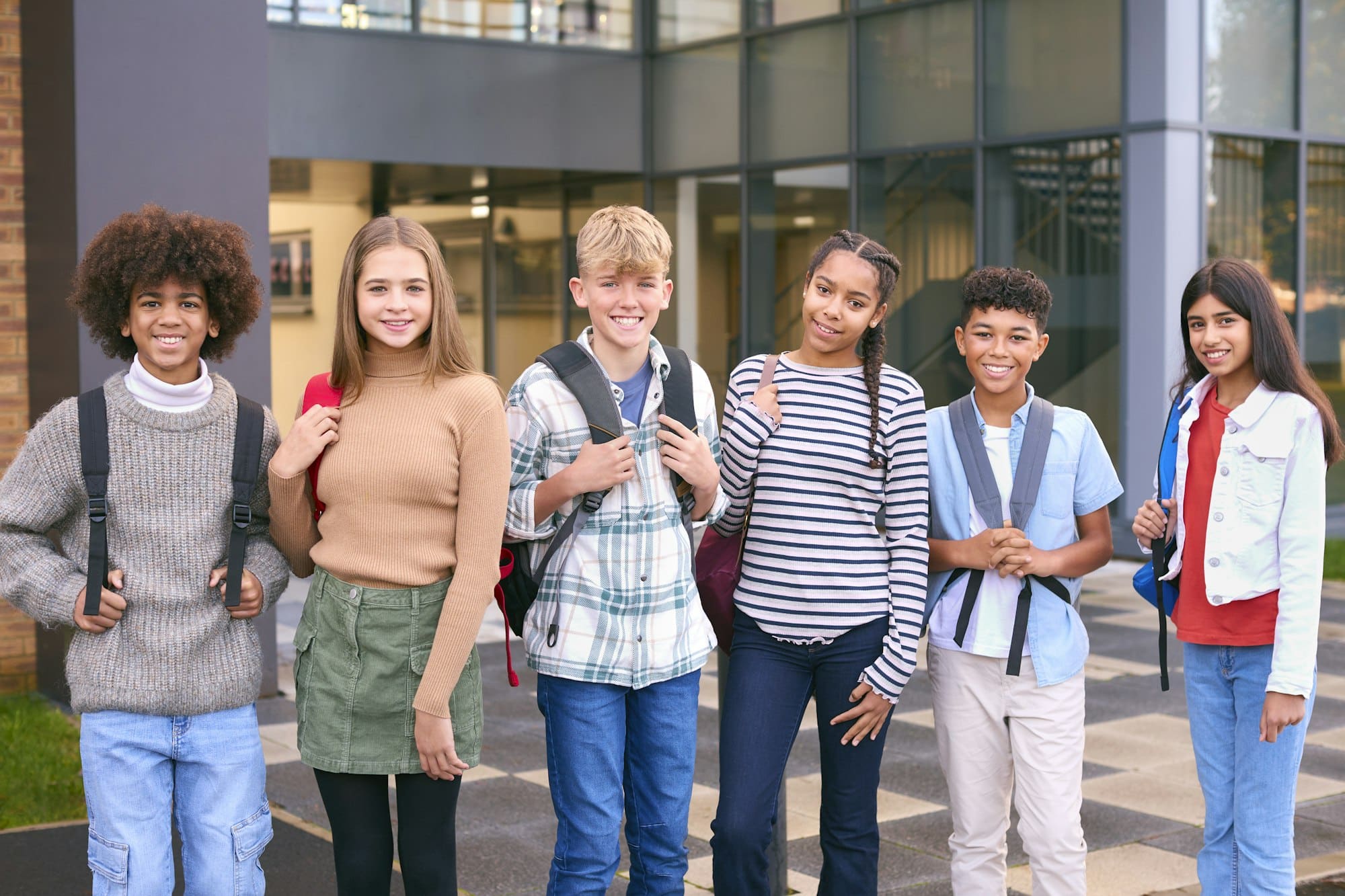 Portrait Showing Class Of Secondary Or High School Pupils Standing Outside School Building