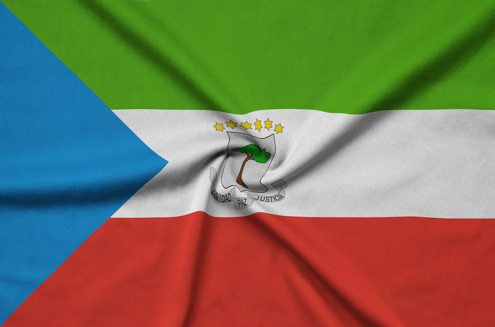 Equatorial Guinea flag is depicted on a sports cloth fabric with many folds