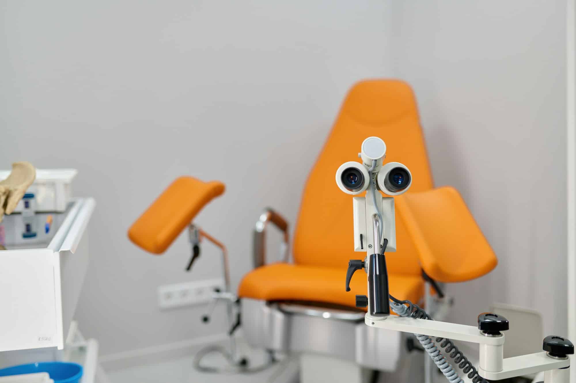 Gynecological chair and examination equipment in modern prenatal clinic office