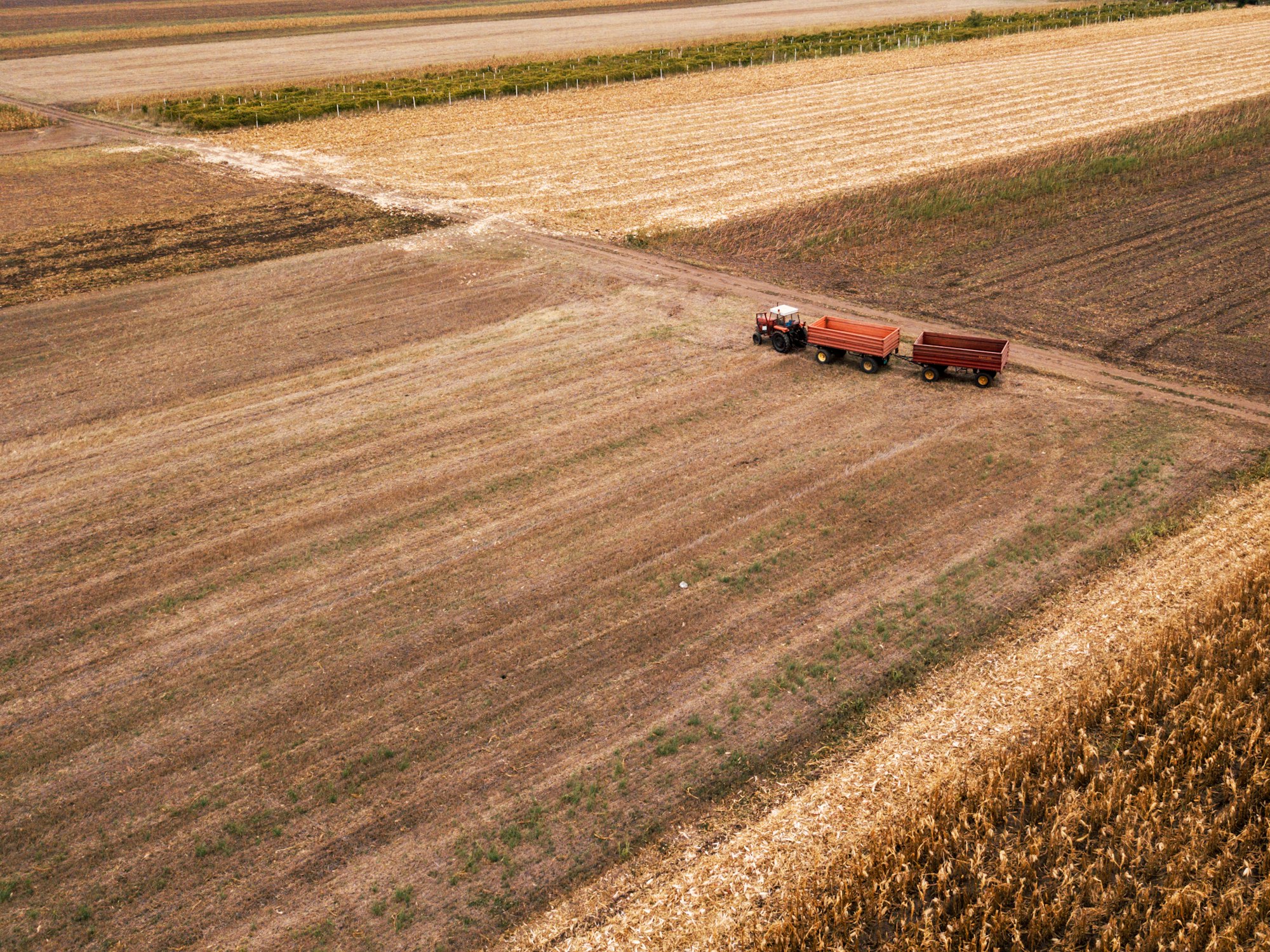 Aerial view of agricultural tractor in the field