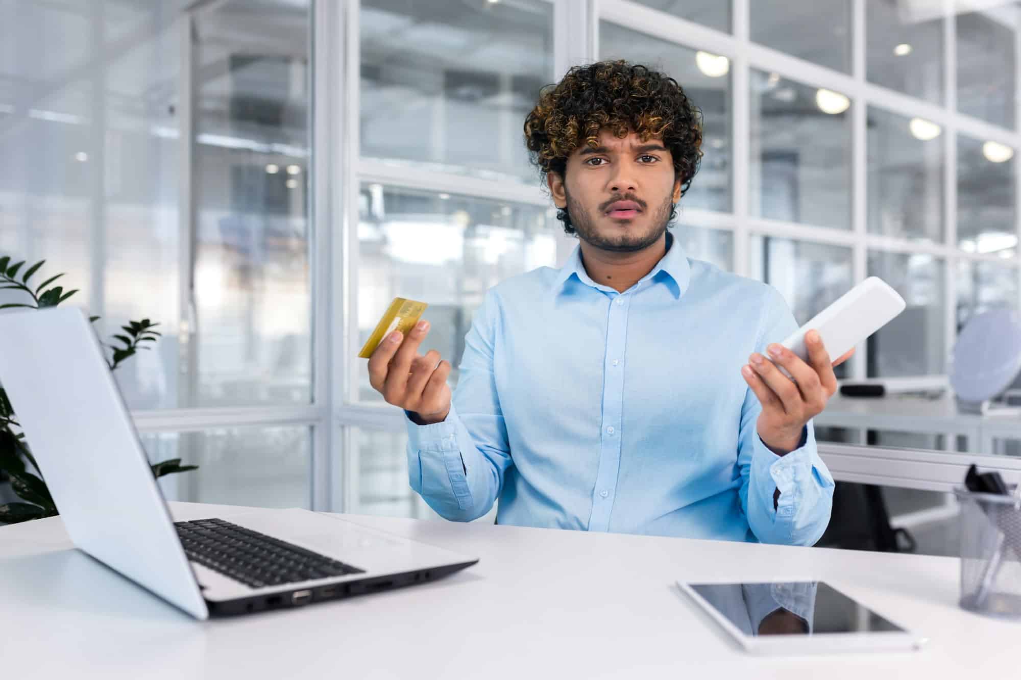 Debt, bankruptcy, foreclosure, fraud. A young Latin American businessman is sitting in the office