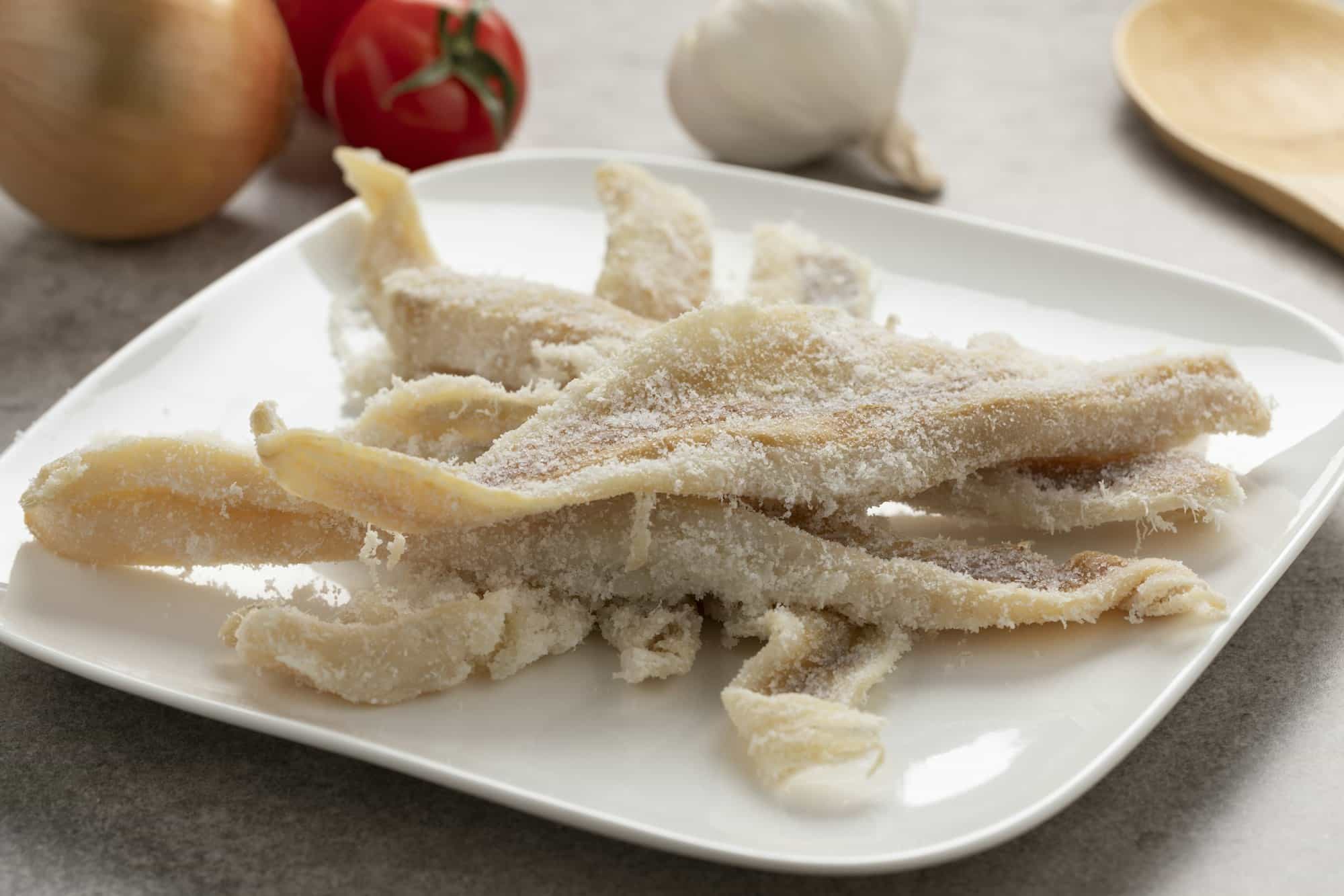 Dried and salted cod on a dish close up