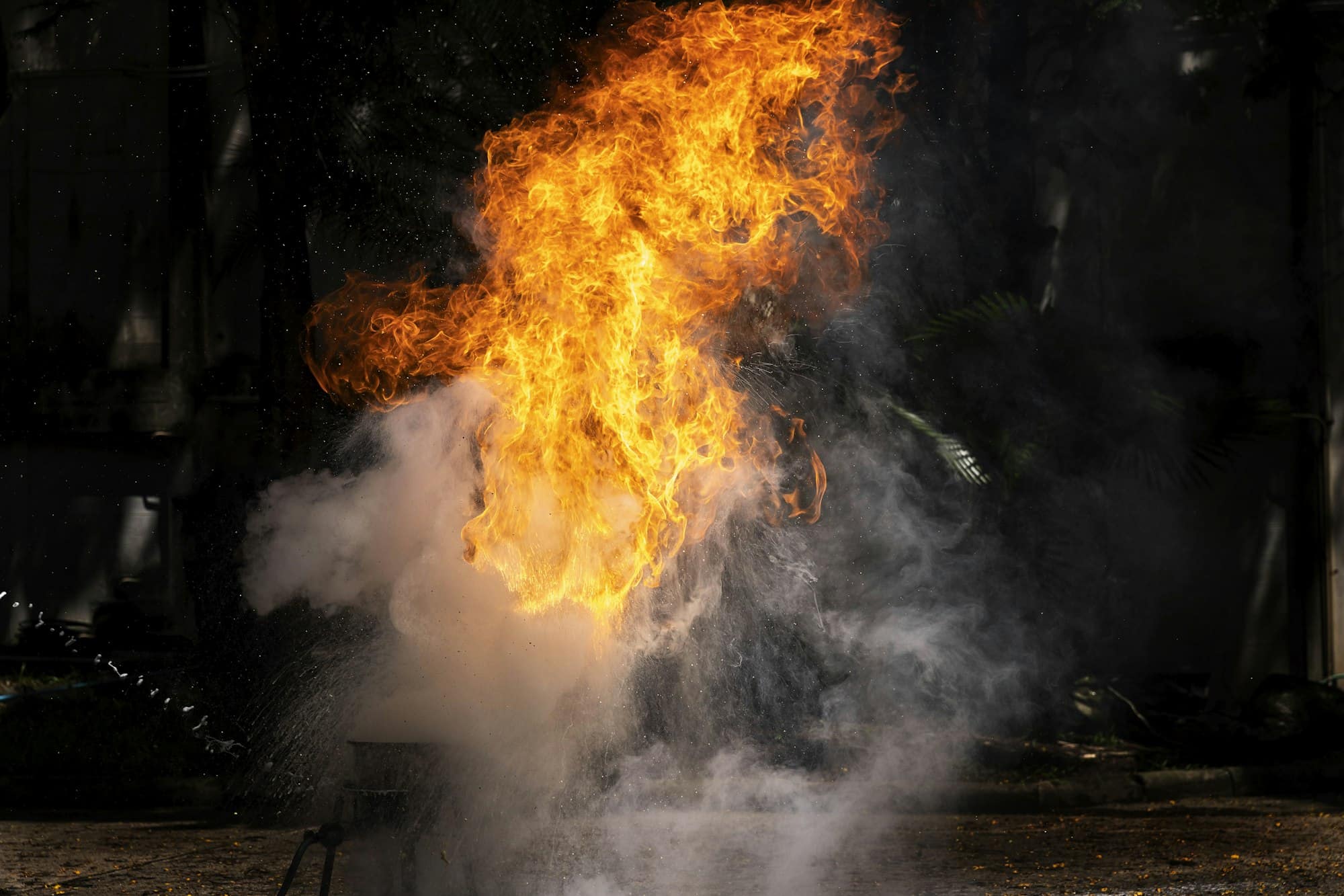 Flames caused by the explosion of the oil. Demonstration of water on oil fire.