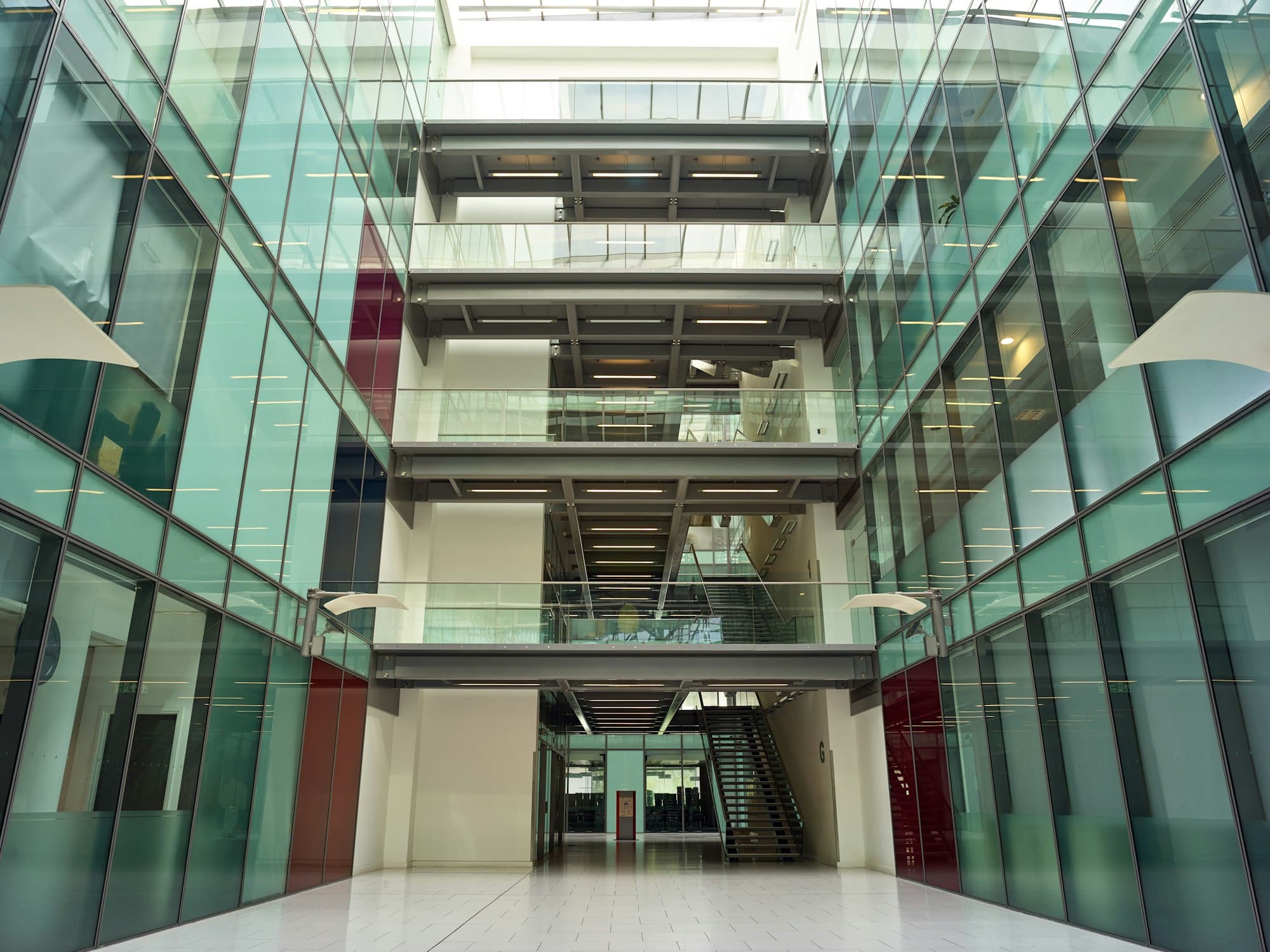 Interior View From Modern Office Lobby Of Empty Floors And Staircases