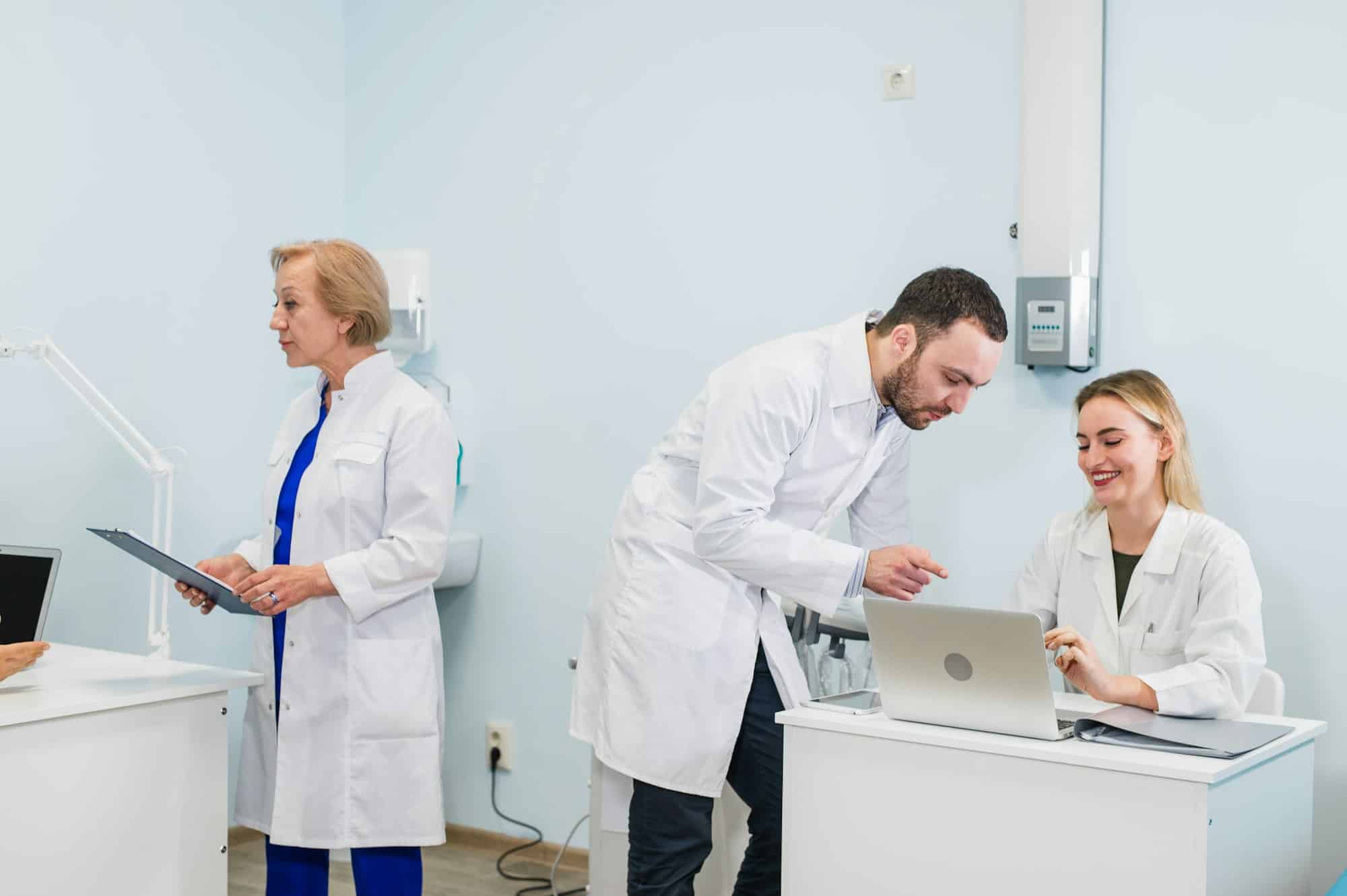 Small group of doctors working together in doctor's office.