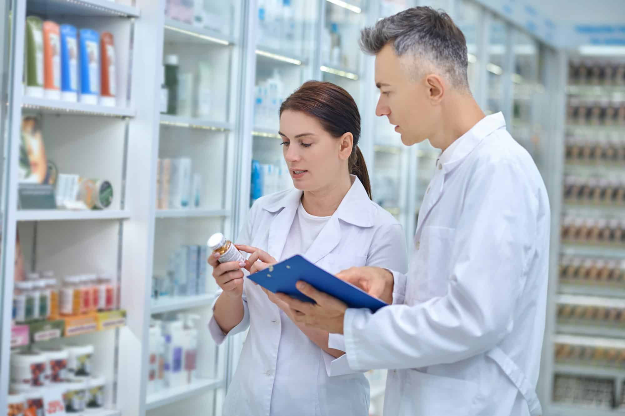 Two pharmacists making medicines revision in a drugstore