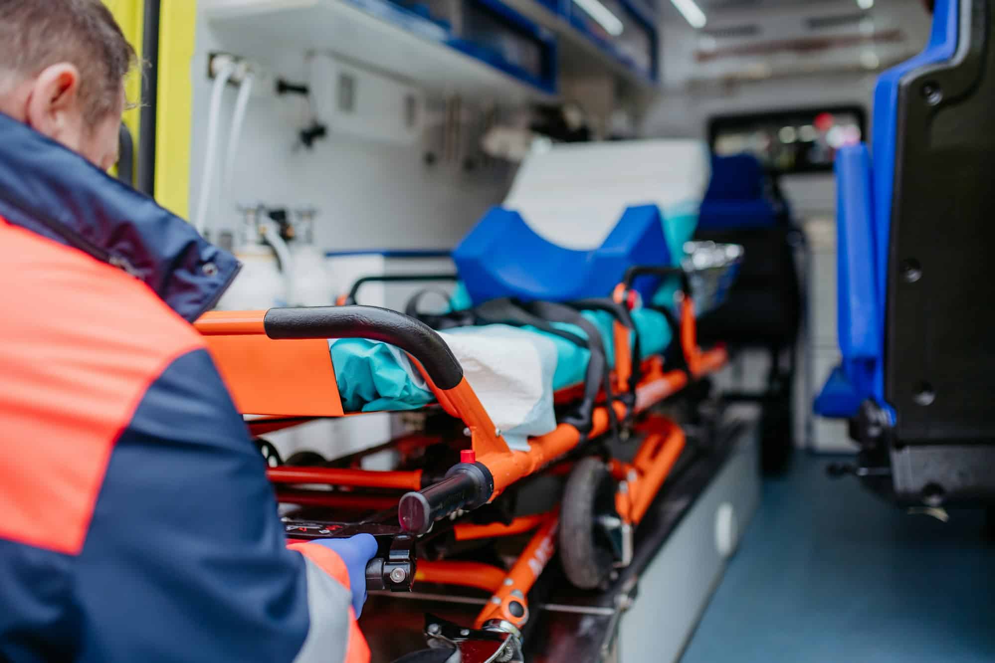 Close-up of empty stretcher inside ambulance vehicle.