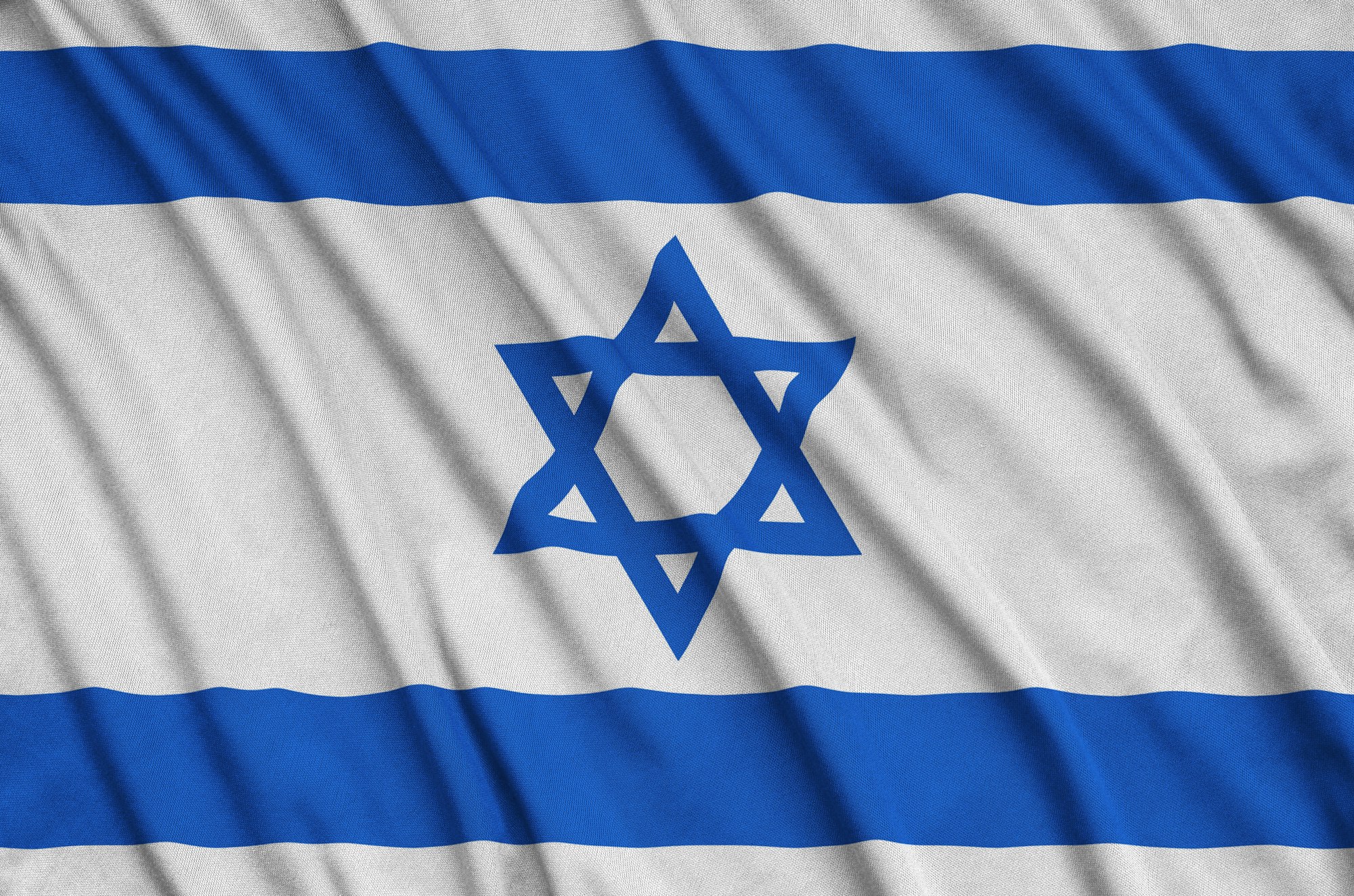 Israel flag is depicted on a sports cloth fabric with many folds. Sport team waving banner