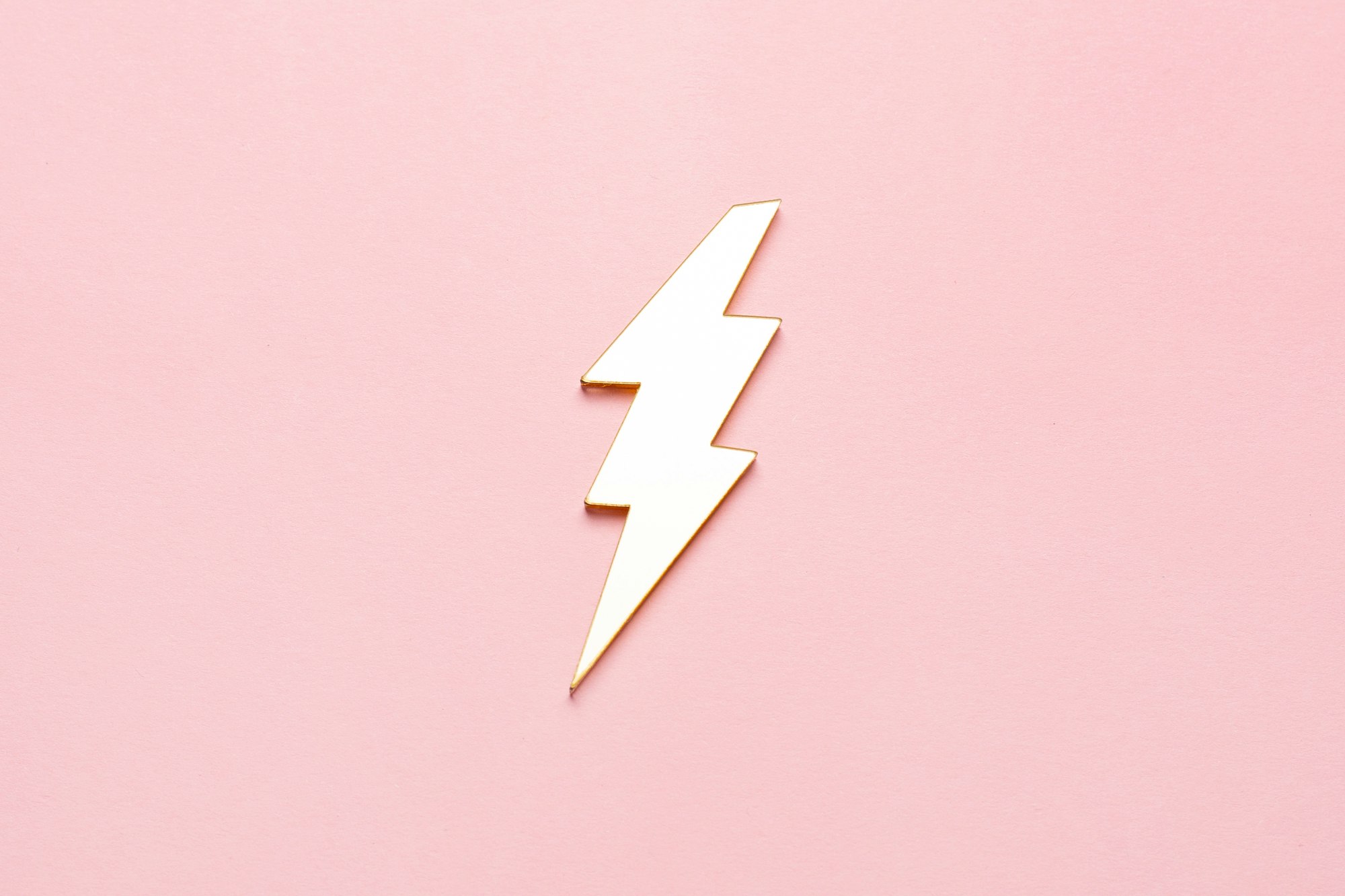 Lightning bolt set isolated on pink. Gold with silver margin.