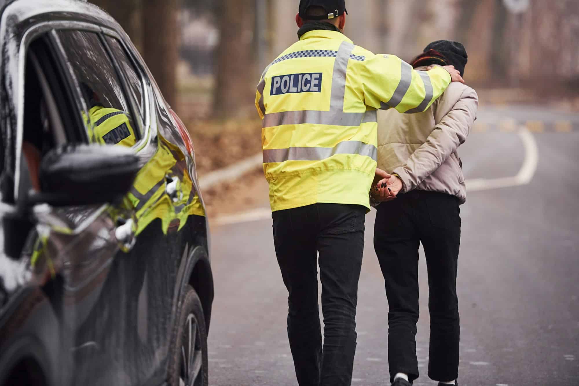 Police officer in green uniform caught automobile theft on the road