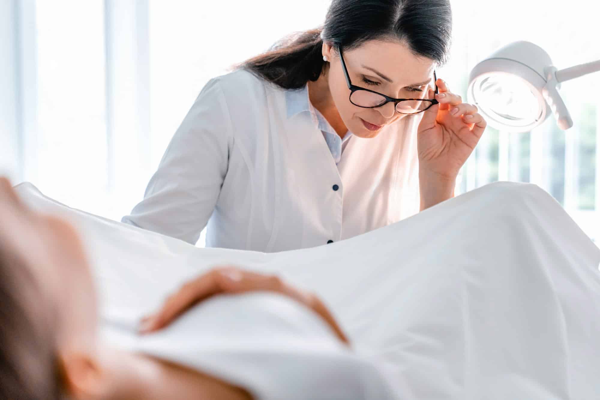 Woman patient in gynecological chair during gynecological check up in clinic