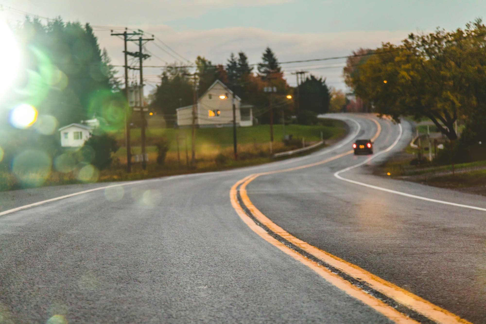 Car driving on road in evening